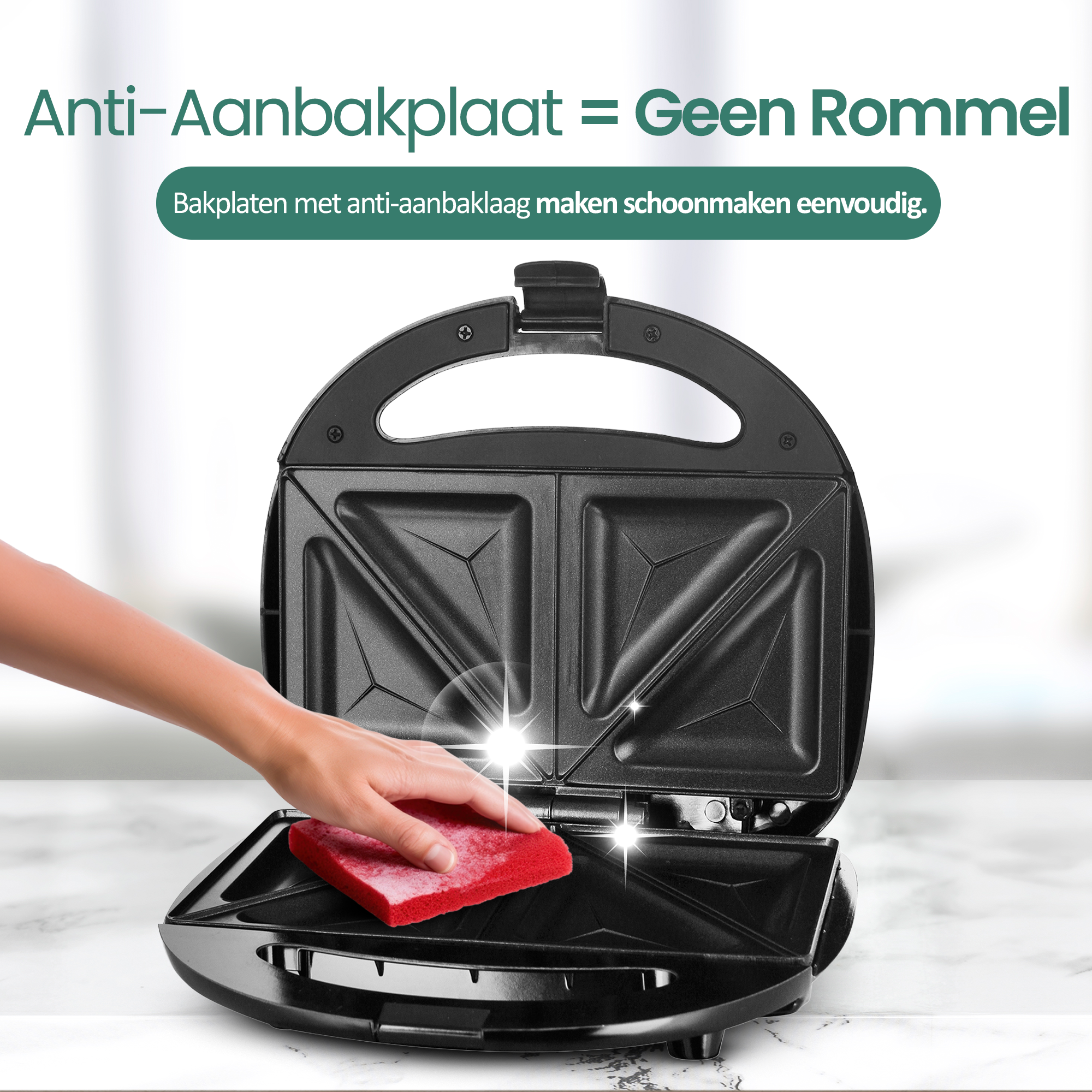 A black sandwich maker is being cleaned with a red sponge. The text in the image says 'Anti-Aanbakplaat = Geen Rommel'.
