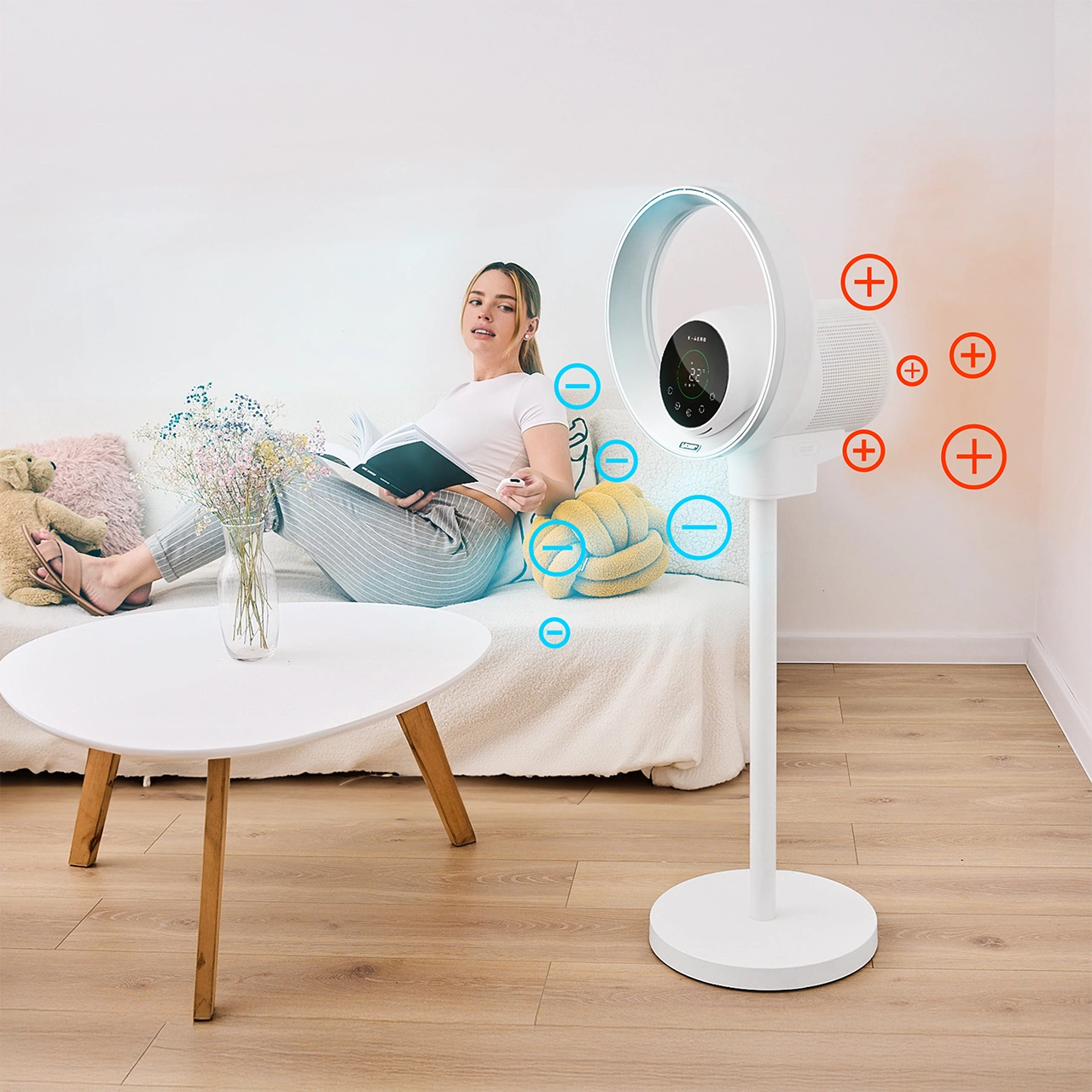 Kobieta relaksuje się na kanapie, czytając książkę. W pobliżu stoi biały wentylator. Kwiaty i stół są na pierwszym planie.