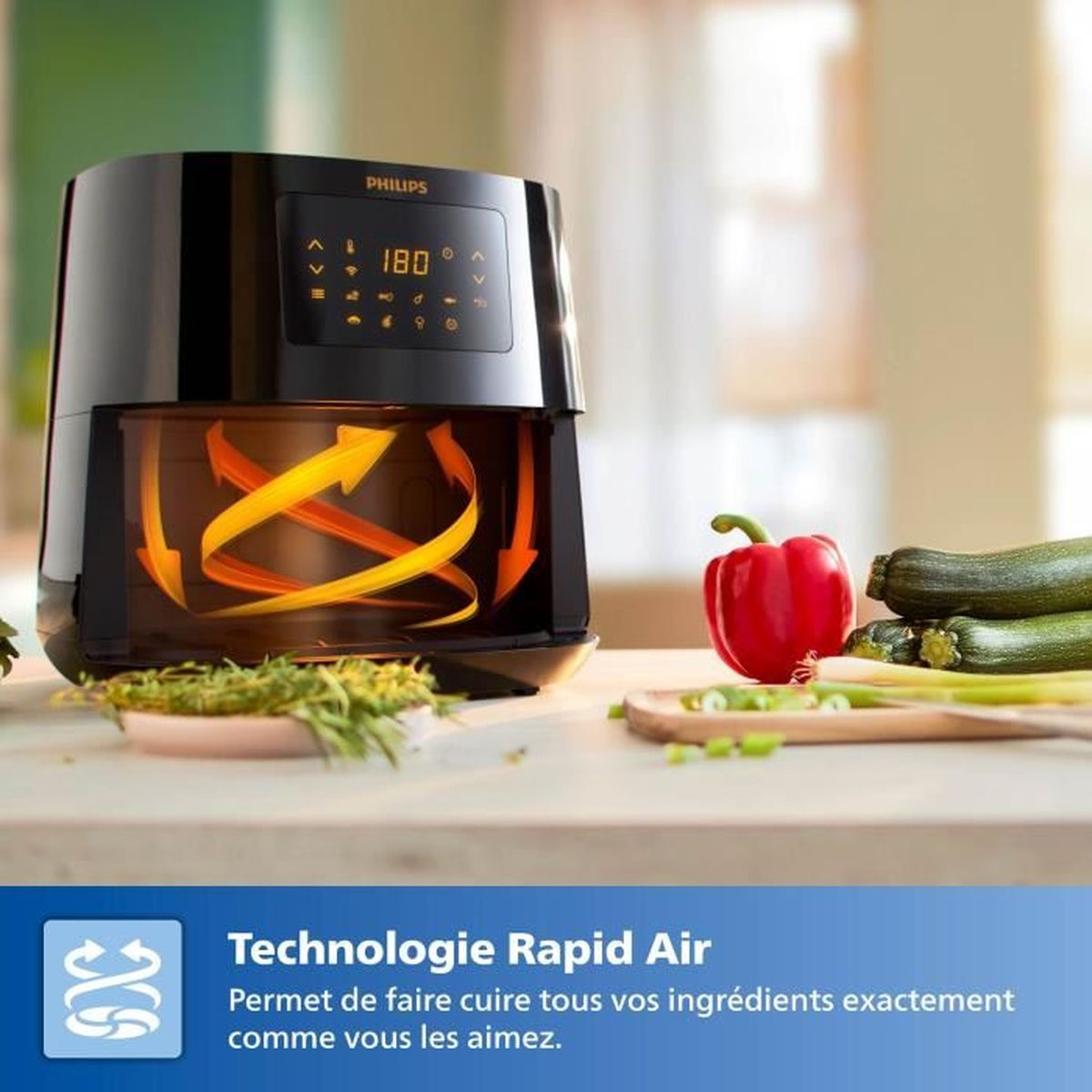 Czarna frytkownica Philips pokazuje 180 stopni. Czerwona papryka i cukinia leżą na drewnianej powierzchni. Wyświetlana jest technologia Rapid Air.
