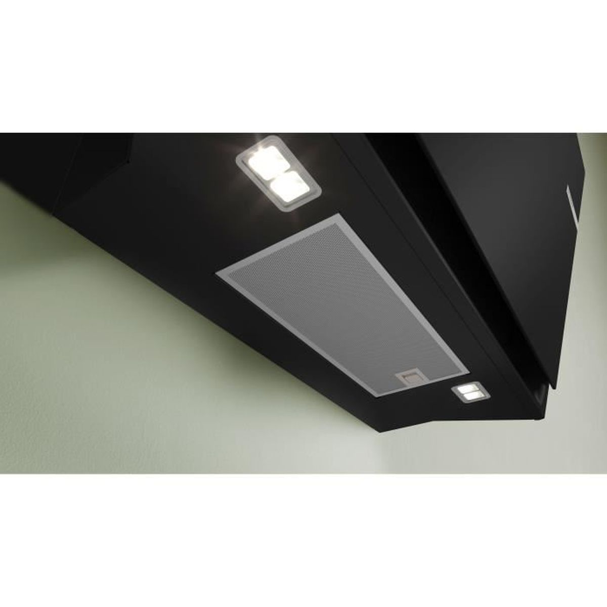A black range hood with lights is mounted on a green wall. It has a mesh panel and two rectangular lights.