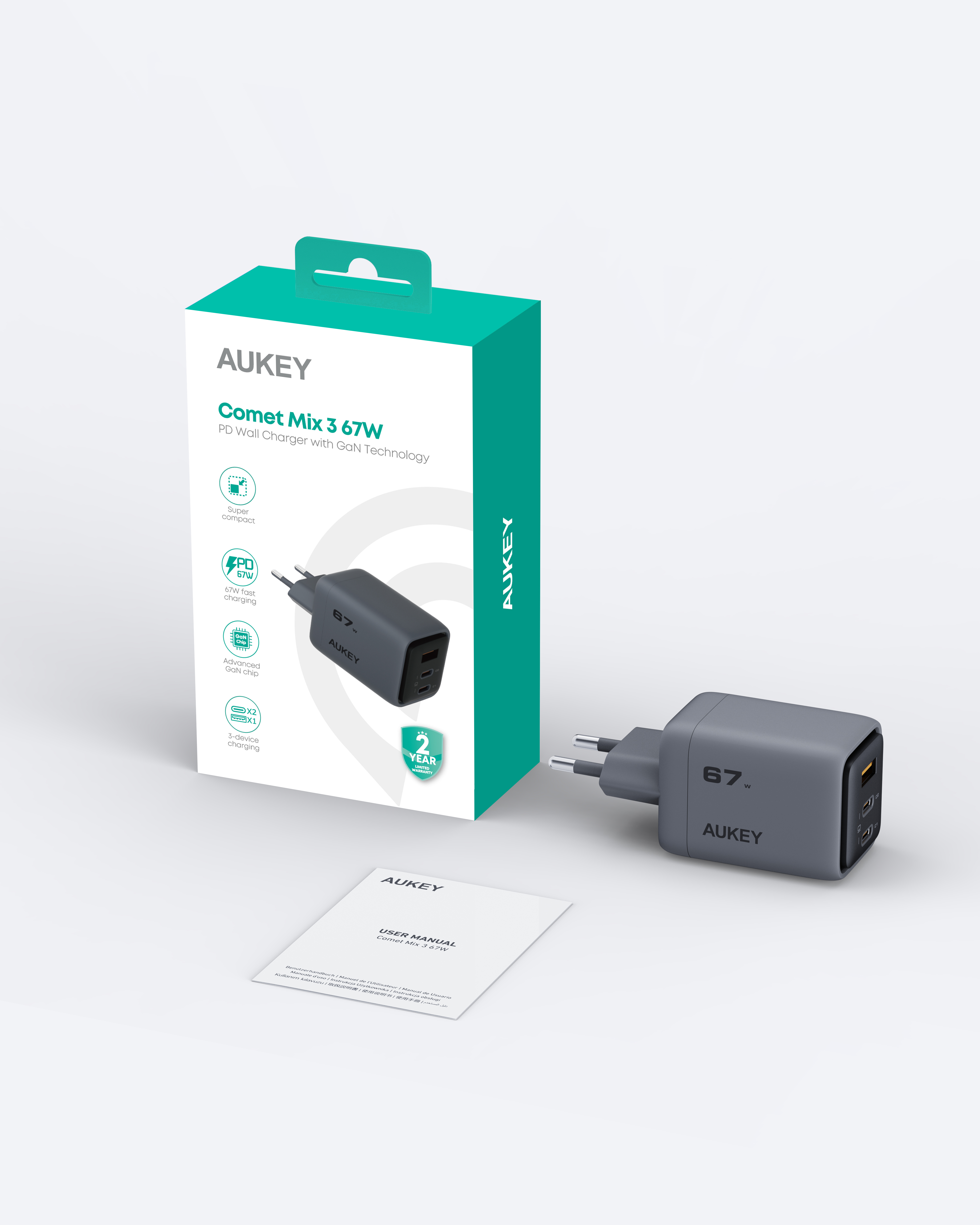 Un cargador AUKEY gris con una caja. La caja dice Comet Mix 3 67W. Un manual de usuario está debajo.