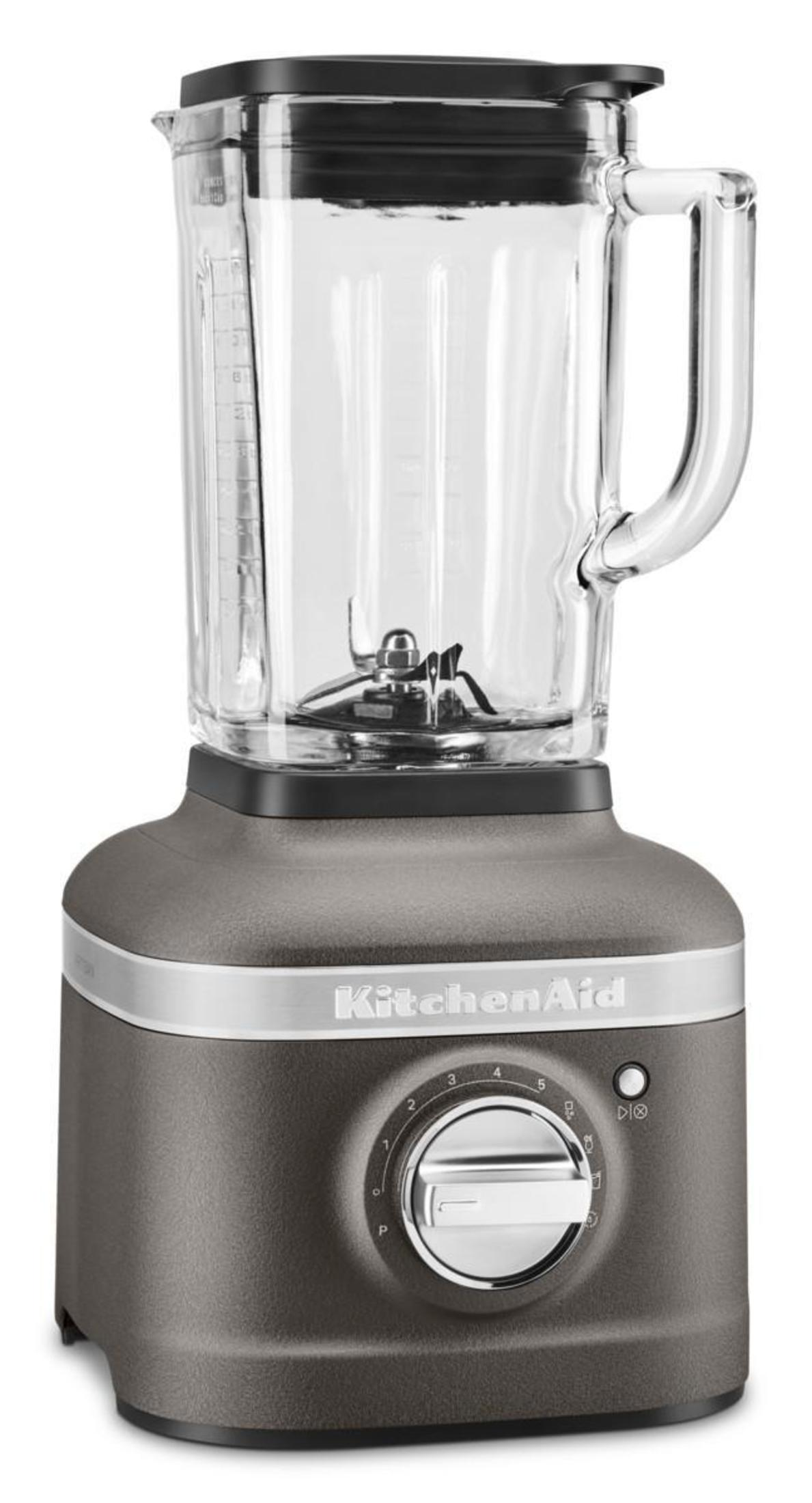A KitchenAid blender. It has a gray base with a clear glass pitcher. The control panel shows settings from P to 8.