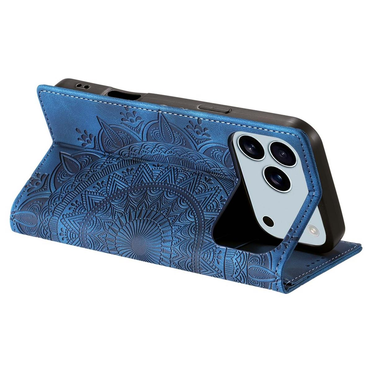 Eine blaue Handyhülle mit Mandalamuster. Ein schwarzes Telefon mit drei Kameras befindet sich darin. Die Hülle ist offen und steht aufrecht.