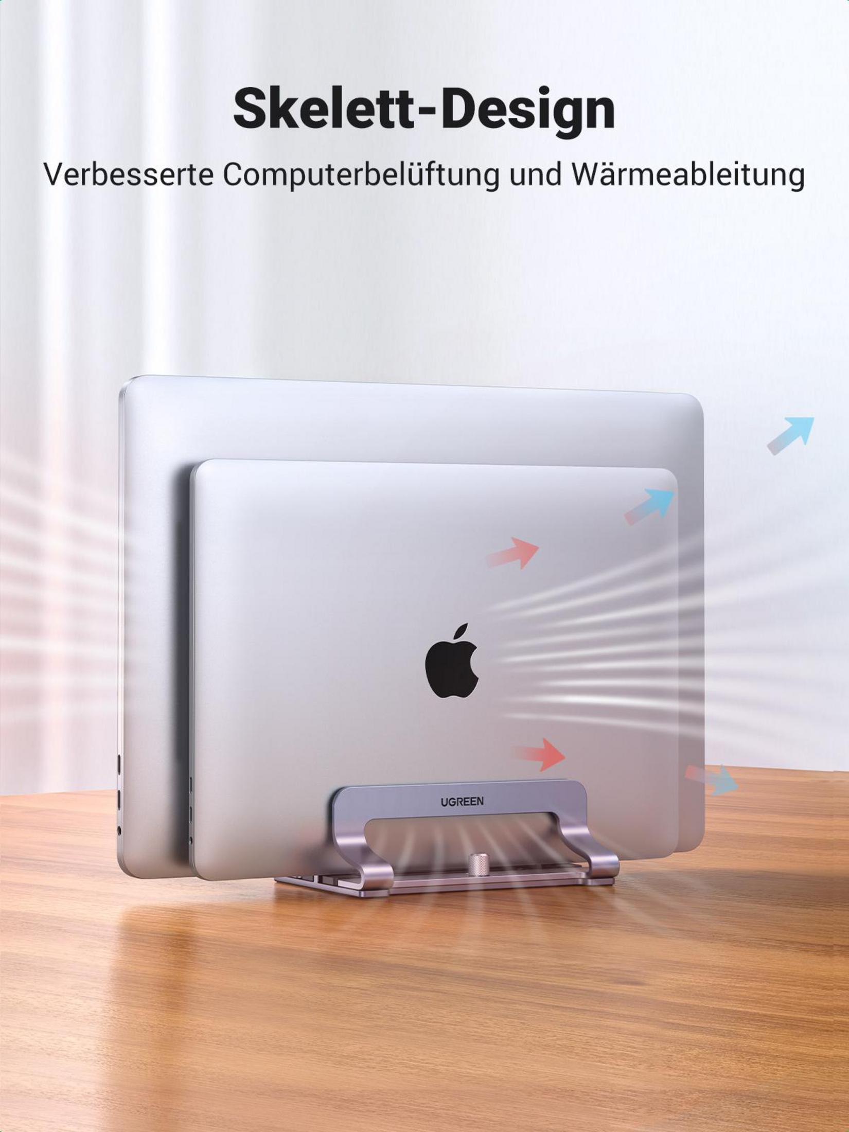 Dwa srebrne laptopy na stojaku. Strzałki pokazują przepływ powietrza do chłodzenia. Stojak na drewnianym stole.