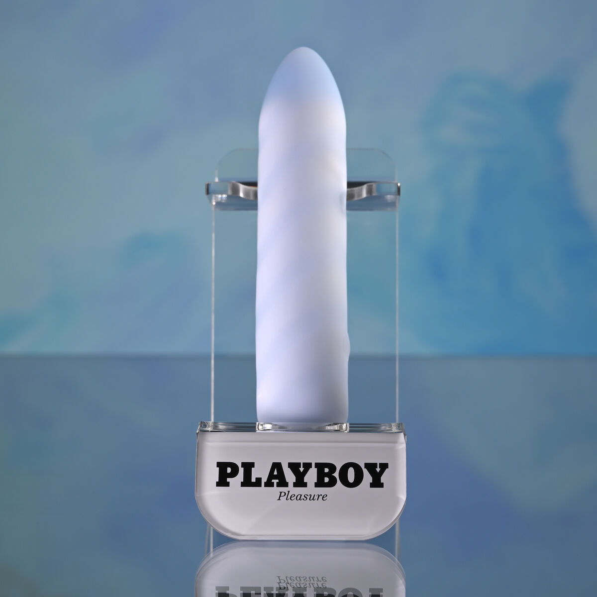 Ein weißes Sexspielzeug in einem durchsichtigen Ständer mit dem Playboy-Logo. Der Hintergrund ist verschwommen blau und weiß.