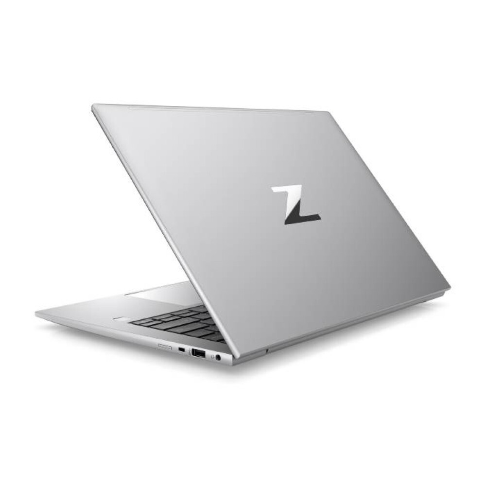 Un portátil plateado abierto sobre fondo blanco. La tapa tiene un gran logotipo 'Z'. Teclado visible. El portátil está ligeramente abierto.