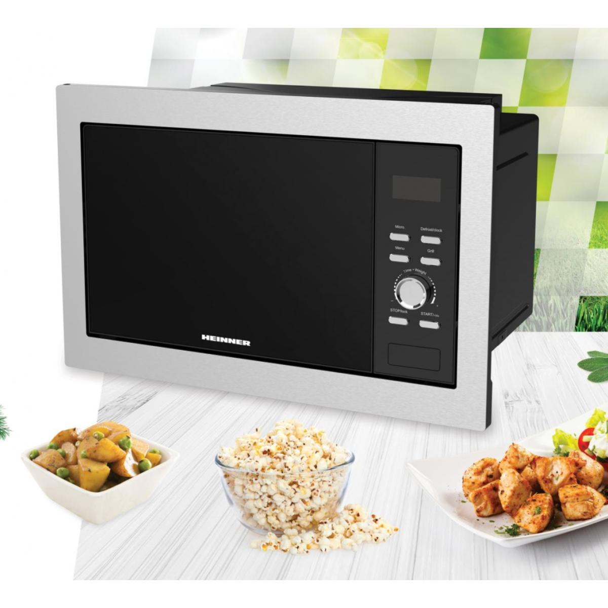 Microwave oven with food: potatoes, popcorn, and chicken. The oven is silver and black, with a digital display.