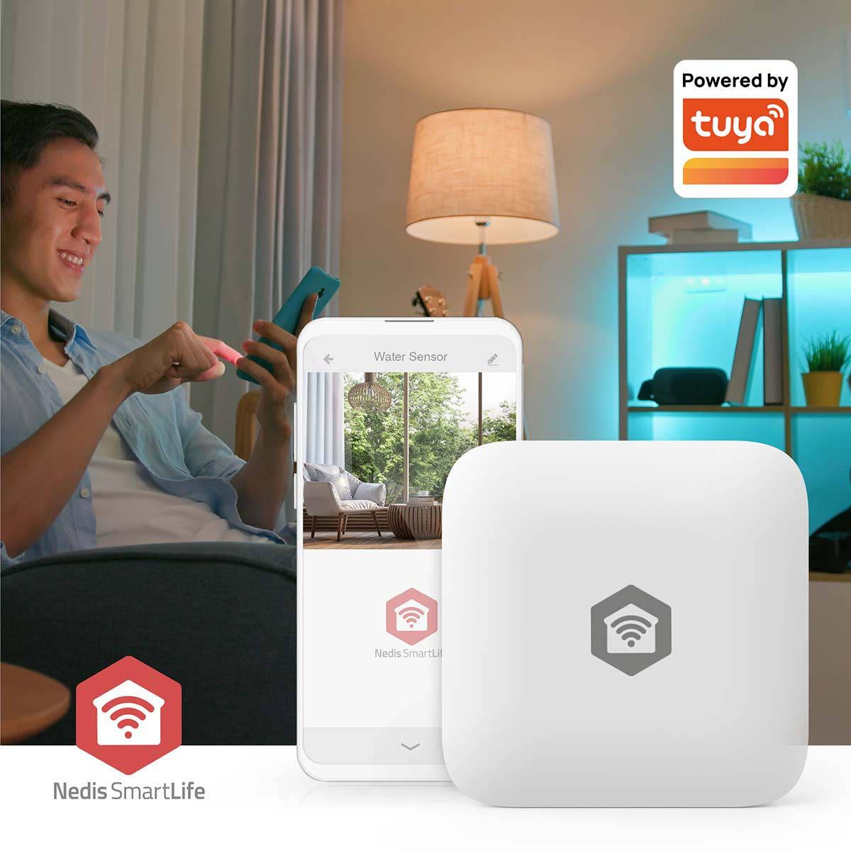 Man using a smartphone with smart home app. Water sensor and a white device in the foreground. Background: lamp, shelves and a window.