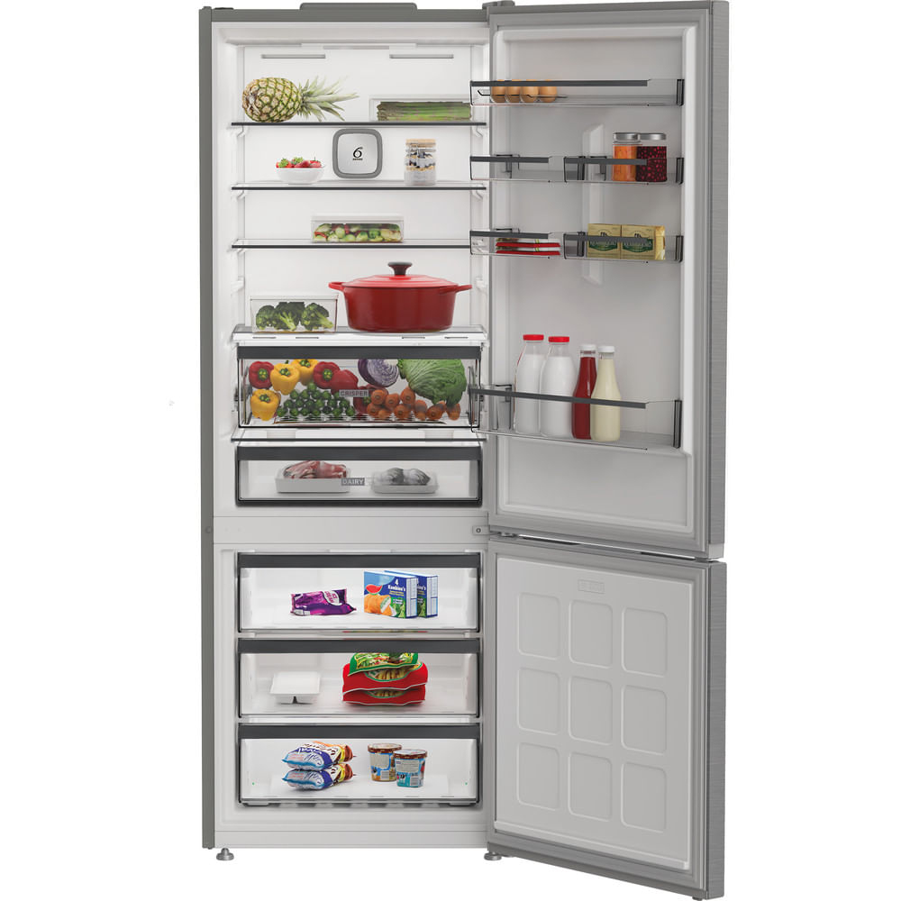 Refrigerador abierto con comida. Piña, fresas, brócoli, olla roja, verduras, carne, leche, jugo y alimentos congelados.