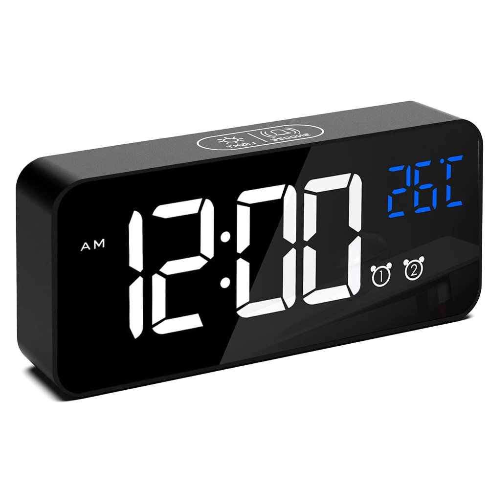 Ein schwarzer digitaler Wecker zeigt '12:00 AM' in Weiß an, mit blauer Temperatur. Knöpfe und Symbole sind auf der Uhr sichtbar.