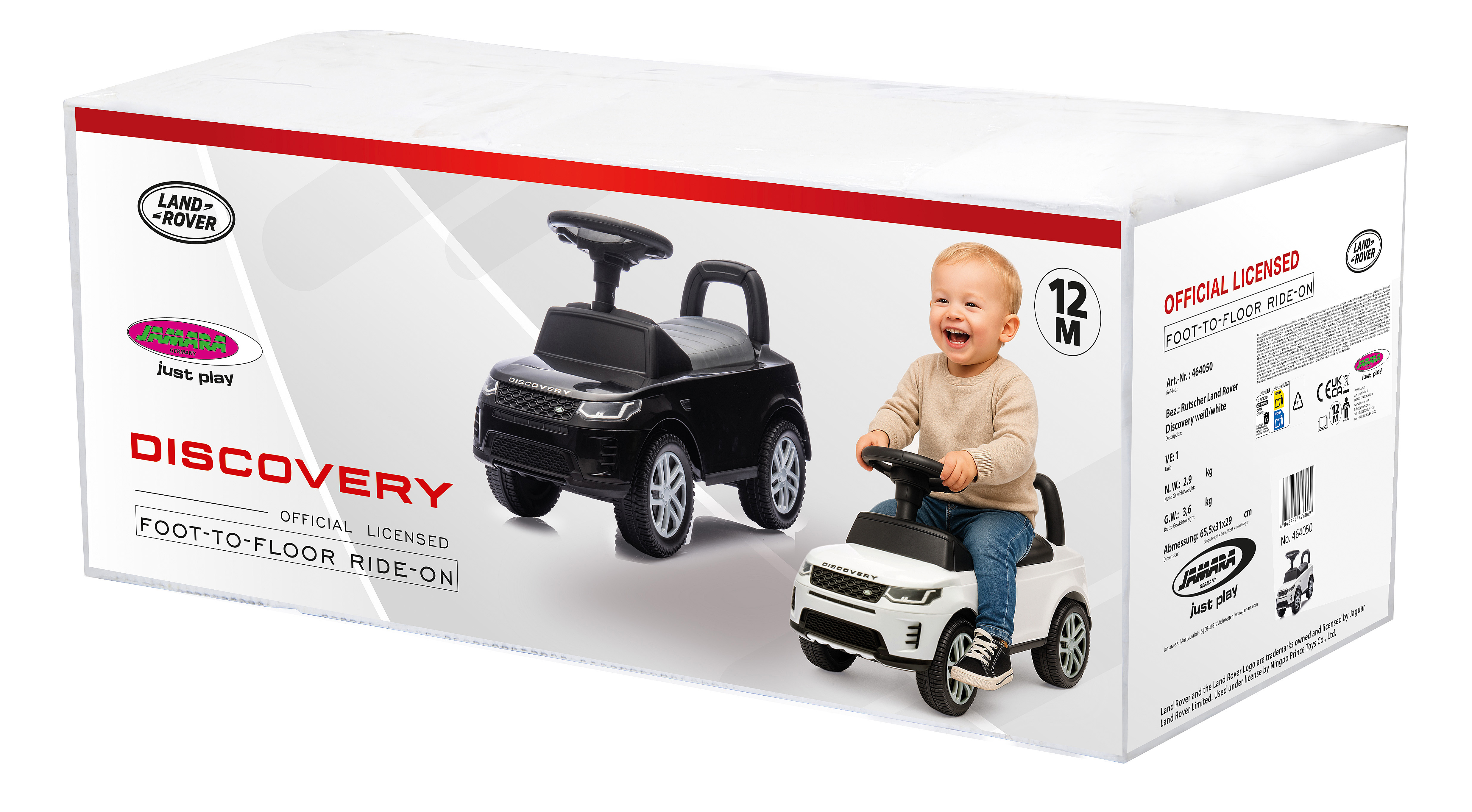 Caja con coches de juguete Land Rover y un niño pequeño. Un coche es negro, el otro blanco. El niño sonríe.