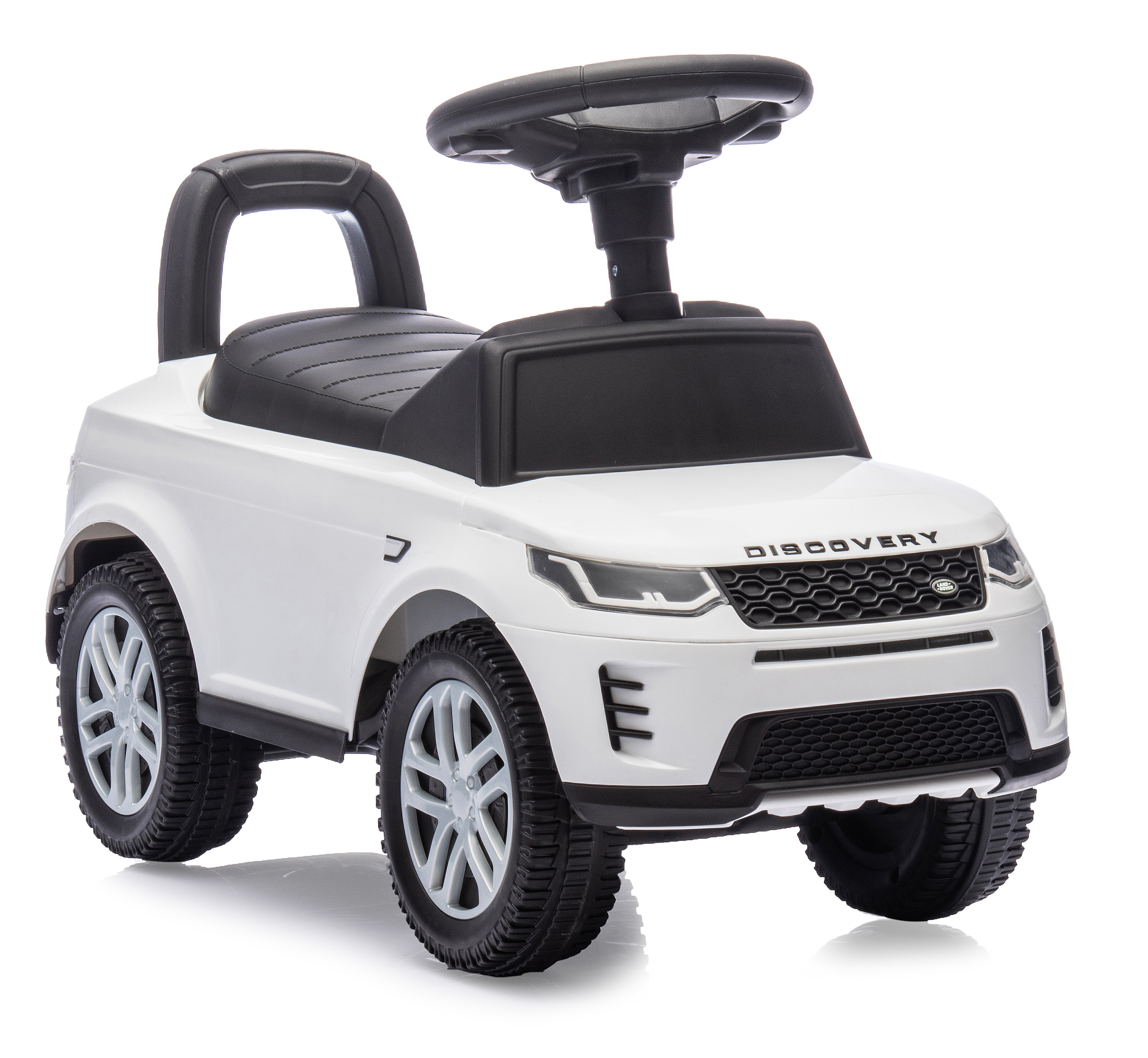 Un coche de juguete blanco con detalles negros. Cuenta con volante, asiento y ruedas, sobre un fondo blanco.
