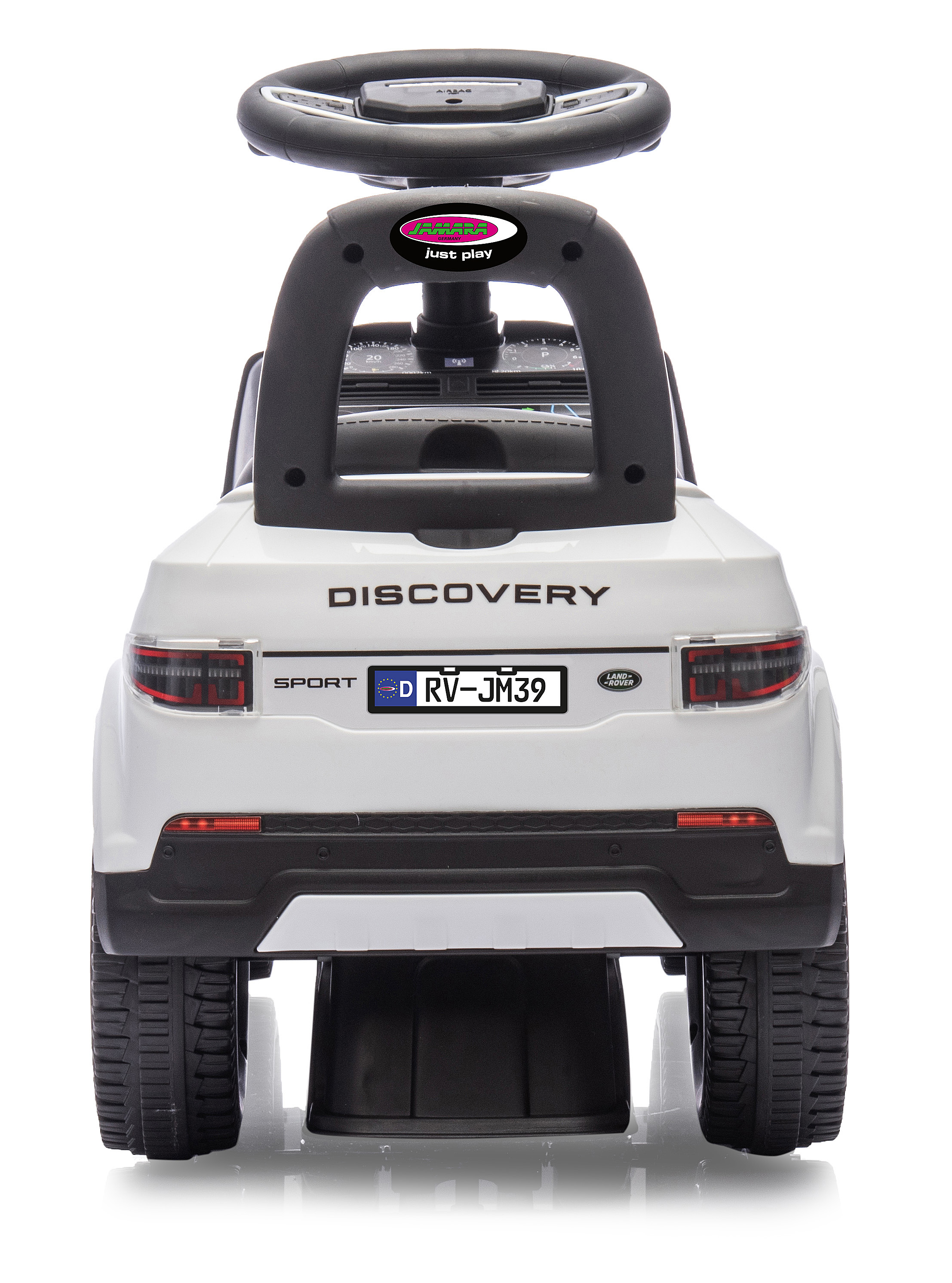Un coche de juguete blanco con detalles negros. Tiene volante, matrícula y la palabra "Discovery".
