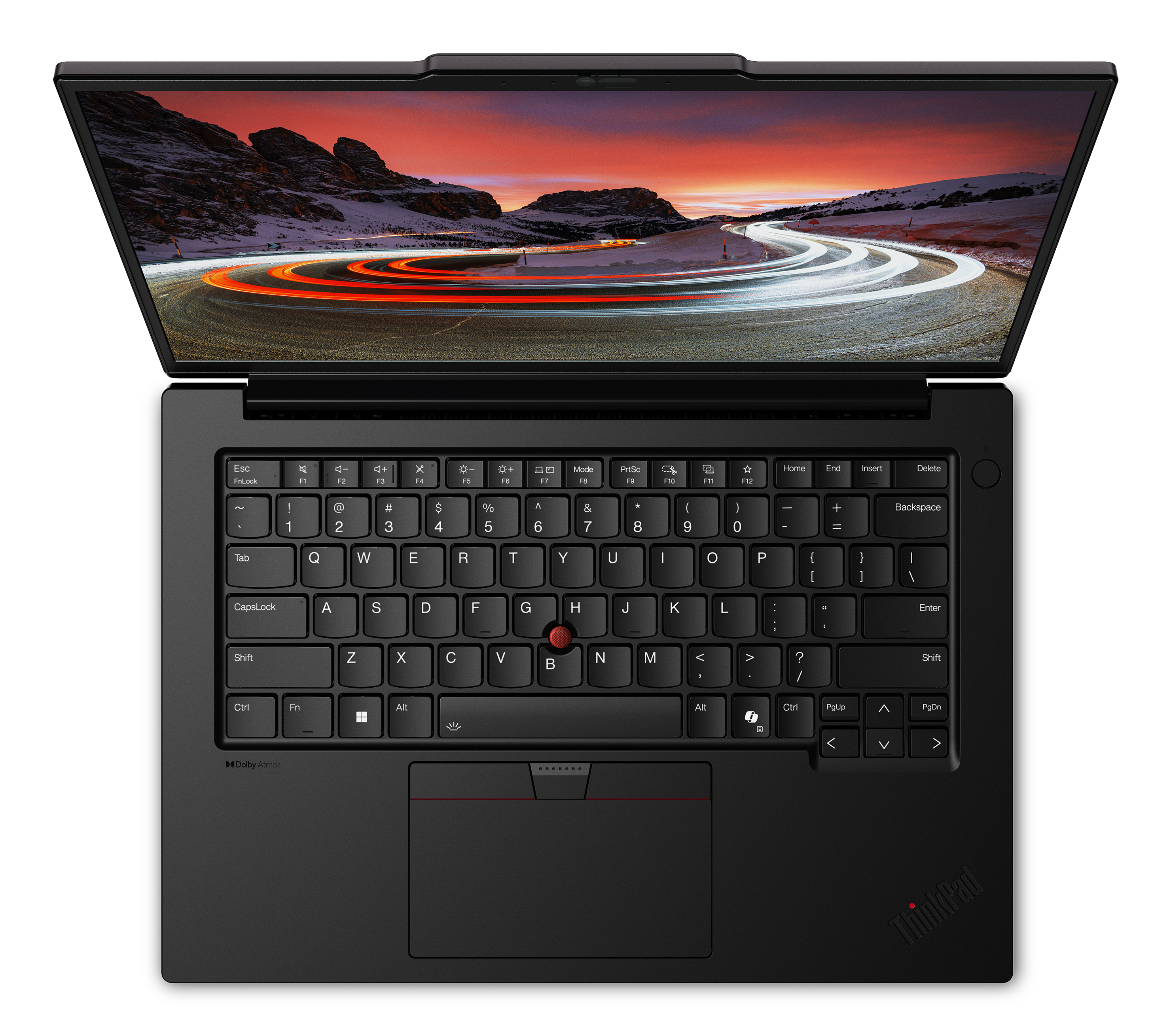 Laptop nero con tastiera aperta, schermo mostra una strada con scie luminose e montagne.