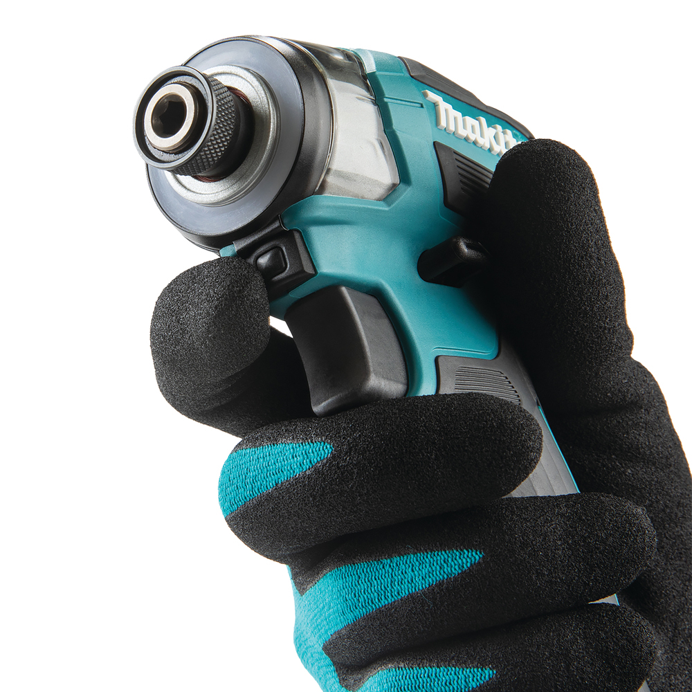 A gloved hand holds a teal and black Makita impact driver. The glove is black with teal accents. White background.