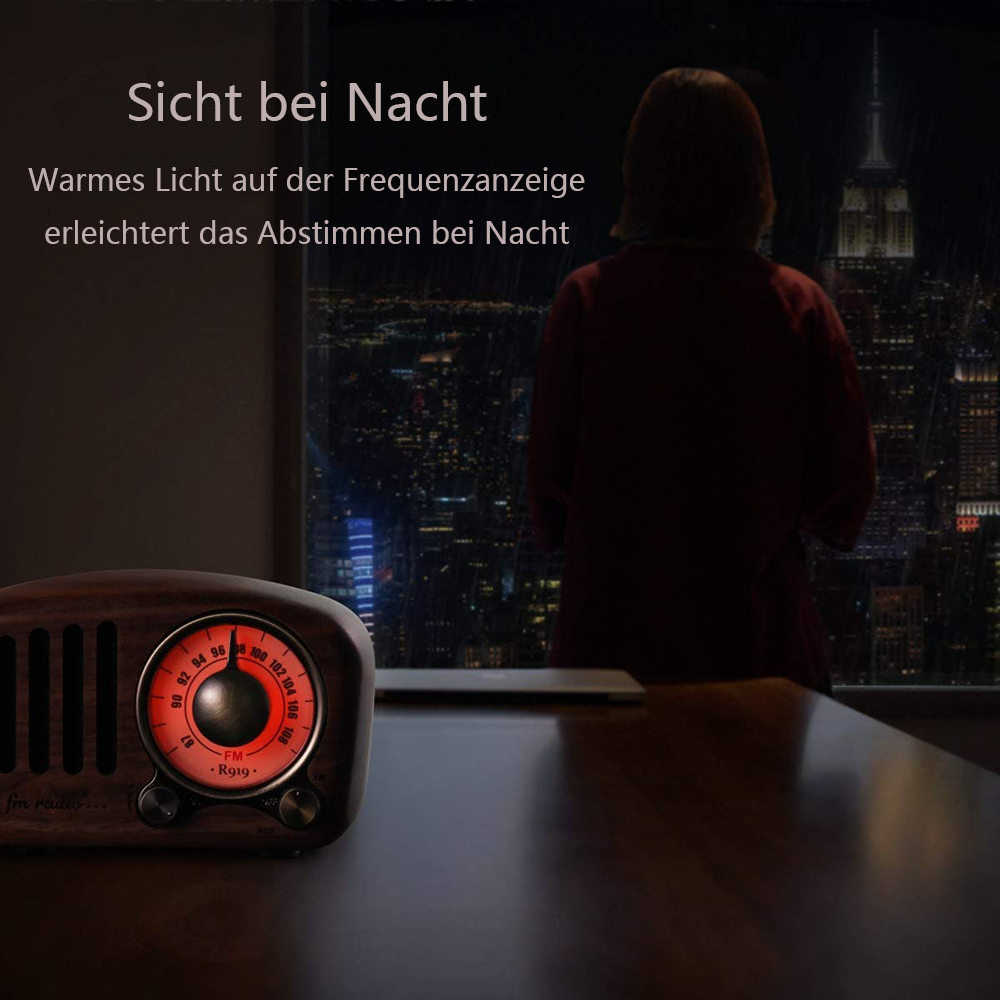 Ein hölzernes Radio mit beleuchtetem Zifferblatt steht auf einem Tisch. Eine Person blickt nachts auf die Skyline einer Stadt.