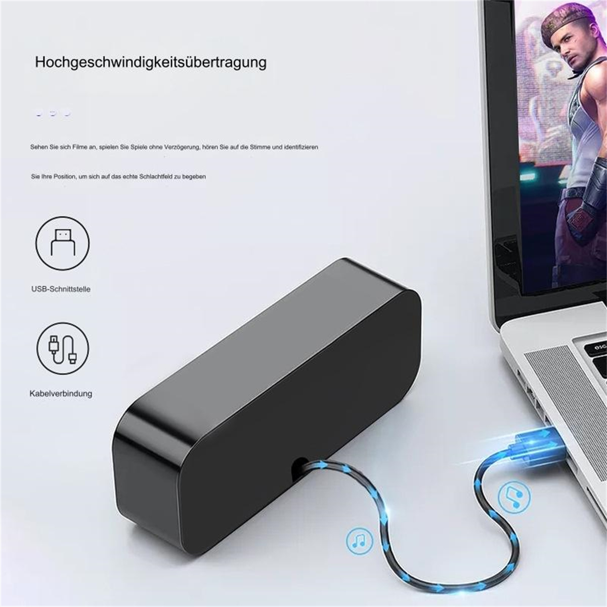 Ein schwarzes Gerät wird über ein USB-Kabel mit einem Laptop verbunden. Der Laptop-Bildschirm zeigt einen Videospielcharakter. Text und Symbole sind sichtbar.