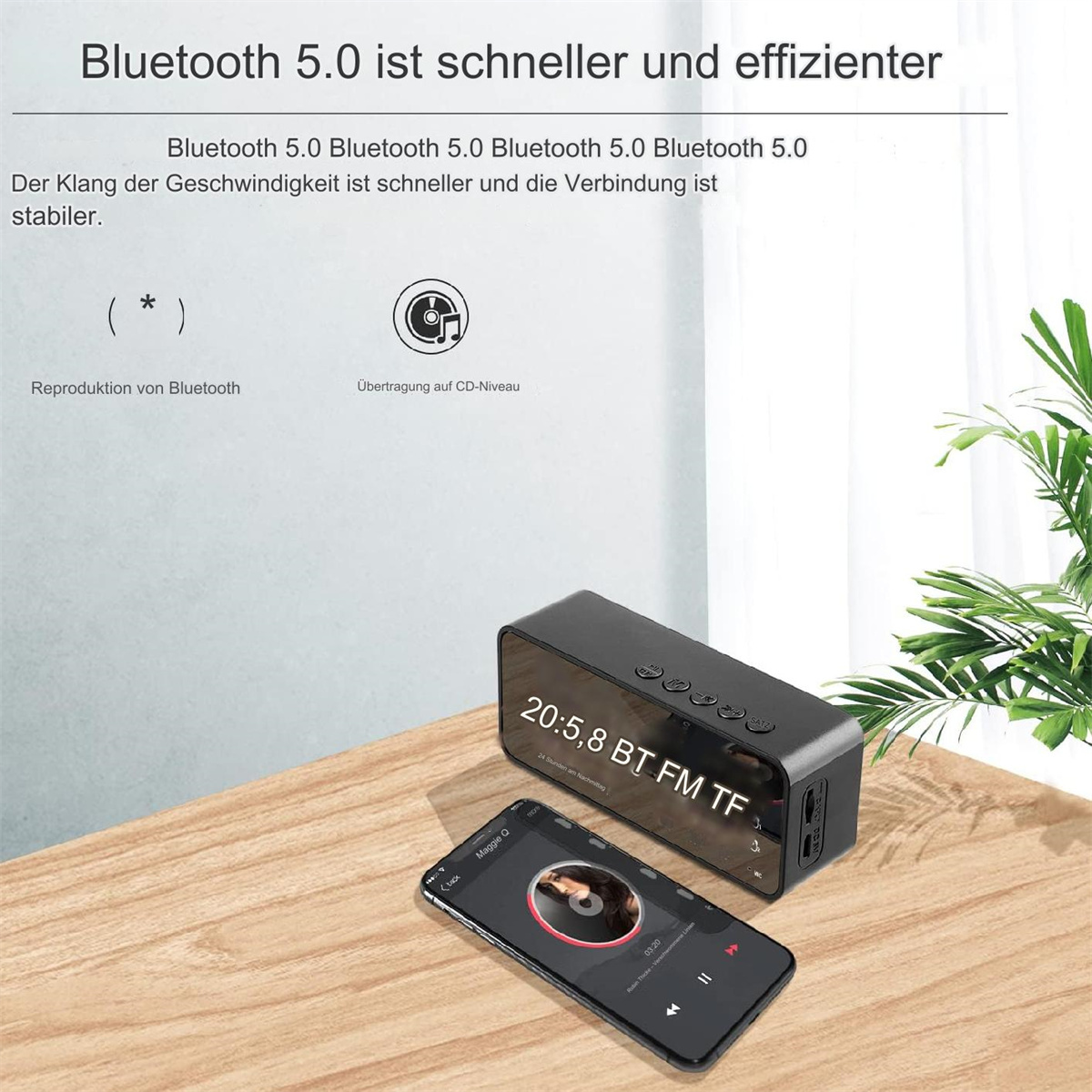 Schwarzer Lautsprecher und Smartphone auf Holzoberfläche. Das Telefon zeigt eine Musik-App. Text über Bluetooth 5.0 steht oben.