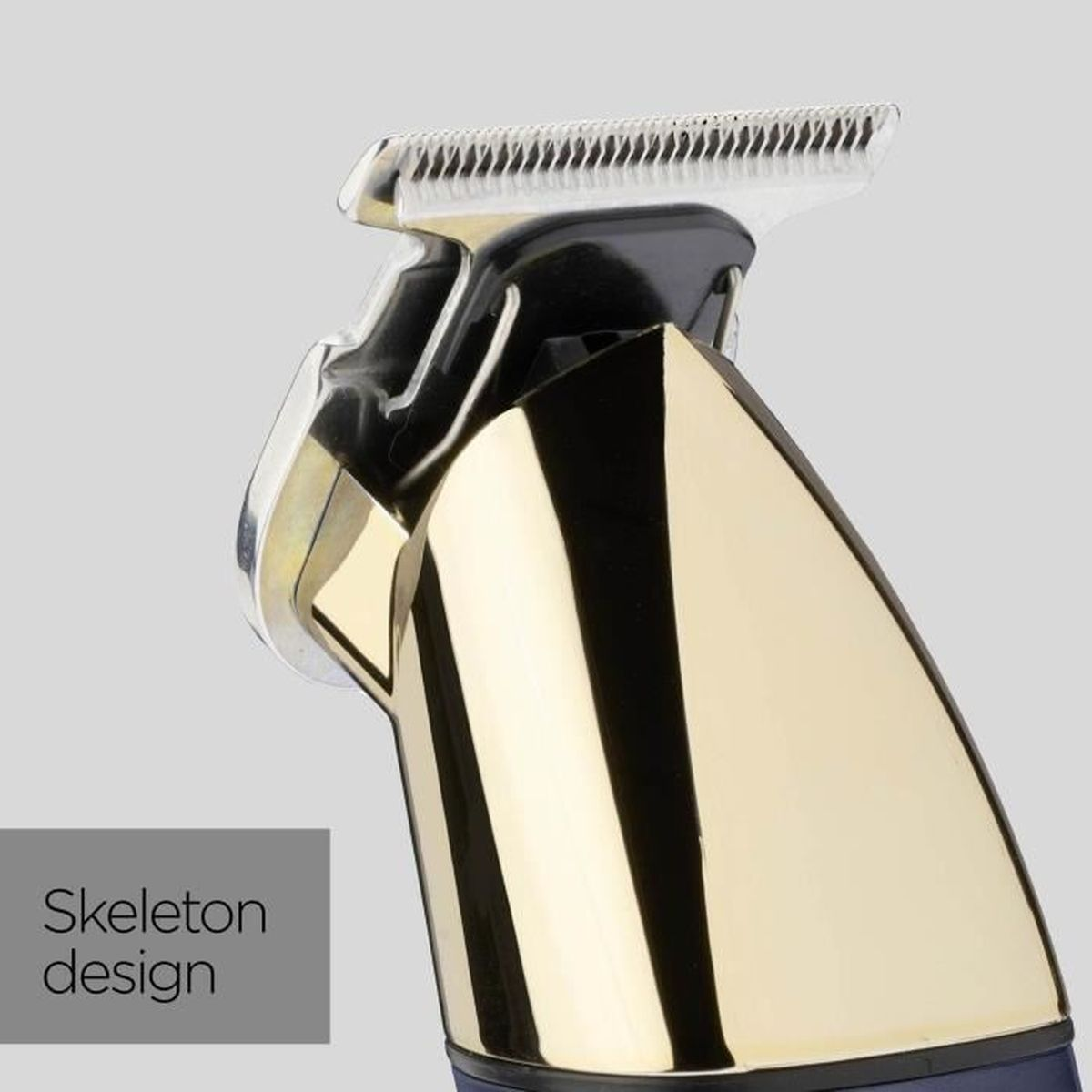 Close-up of a gold and black hair clipper with a silver blade. The background is a light gray color.