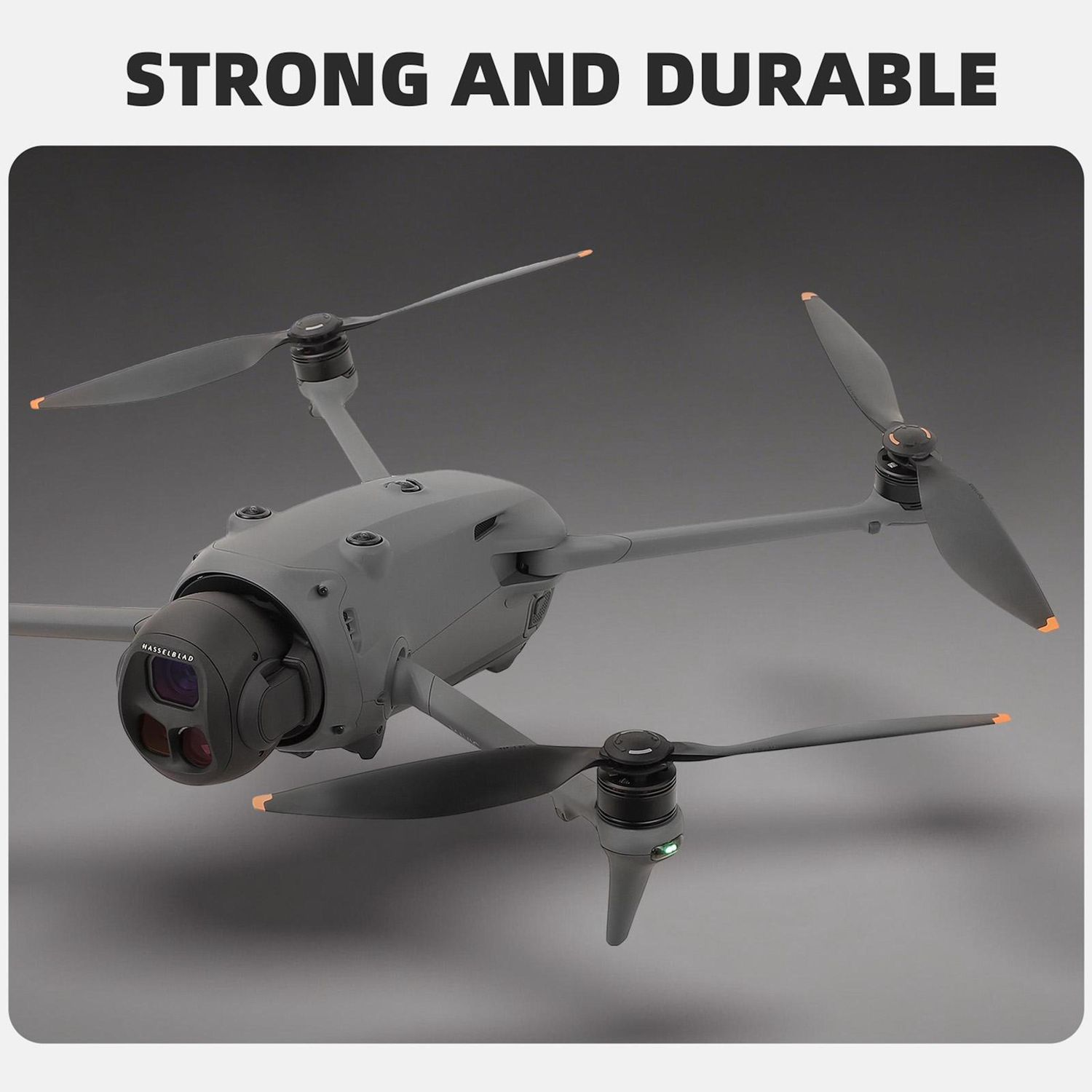 Un drone grigio con quattro eliche è in primo piano. Il testo "STRONG AND DURABLE" è in alto. Lo sfondo è una sfumatura di grigio.