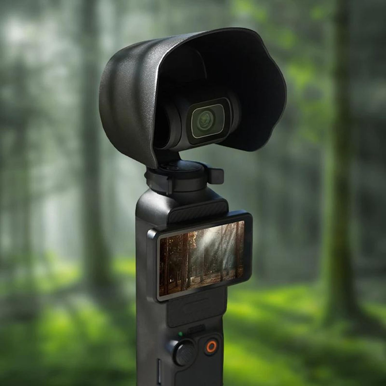 Una fotocamera portatile nera con uno schermo che mostra una scena di foresta. Ha un paraluce, pulsanti ed è ambientata su uno sfondo sfocato di foresta.