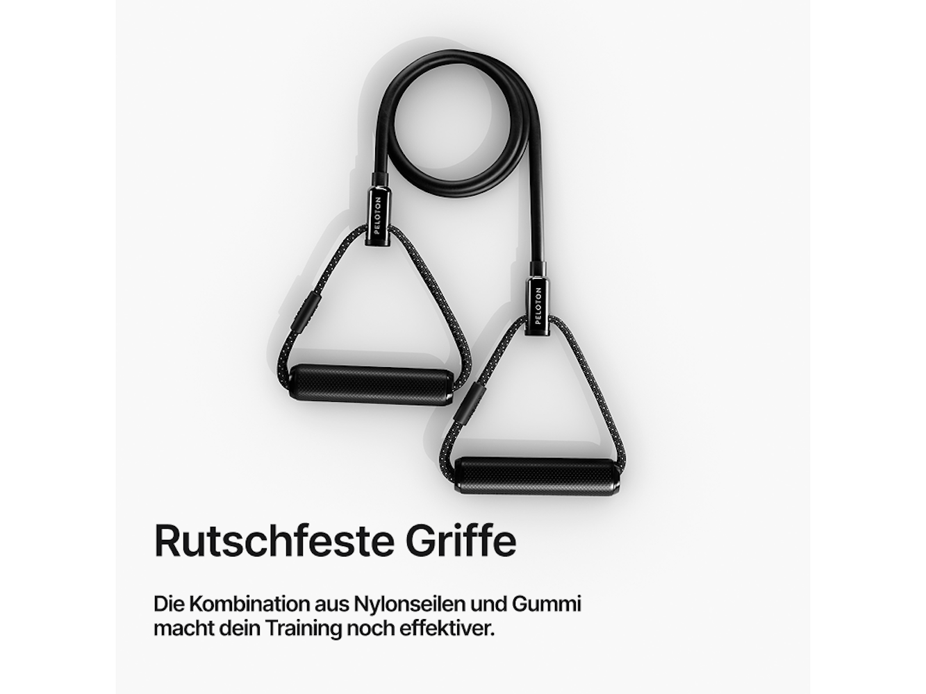 Schwarzes Peloton-Widerstandsband mit zwei Griffen, weißer Hintergrund. Text: 'Rutschfeste Griffe'.