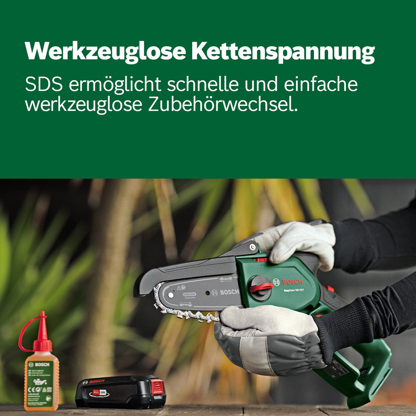 Bir kişi bir Bosch motorlu testere tutuyor. Yağ ve bir pil masanın üzerinde. Arka plan bulanık yeşil.