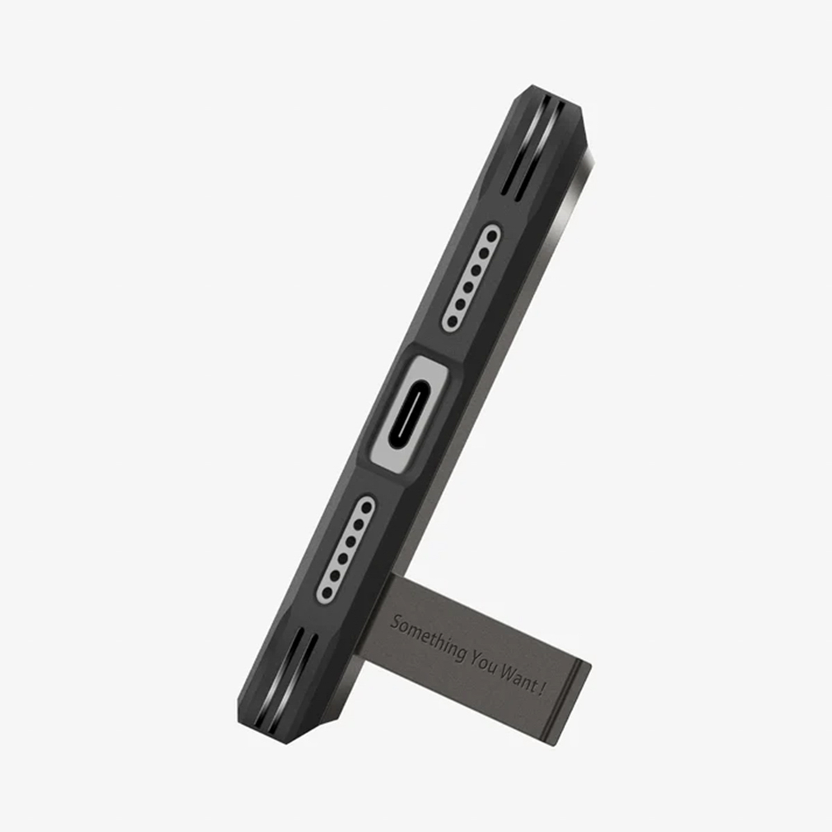 Une coque de téléphone noire avec un support. La coque a un port et des trous pour haut-parleur. Le support indique 'Something You Want!'