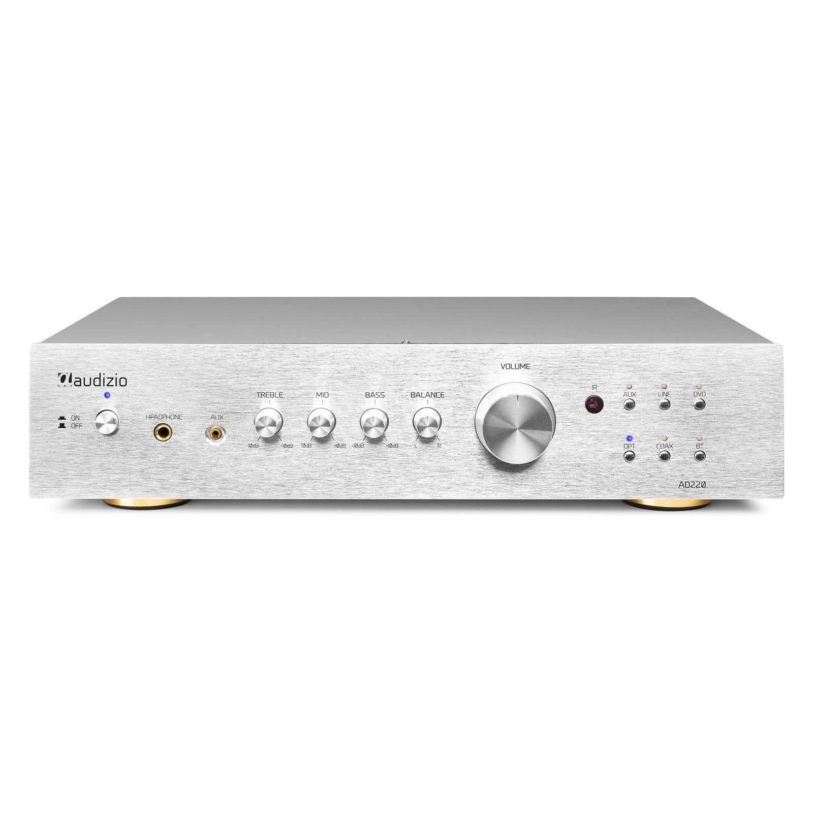Receptor de audio plateado con múltiples perillas y botones. Tiene una perilla de volumen y botones de selección de entrada.