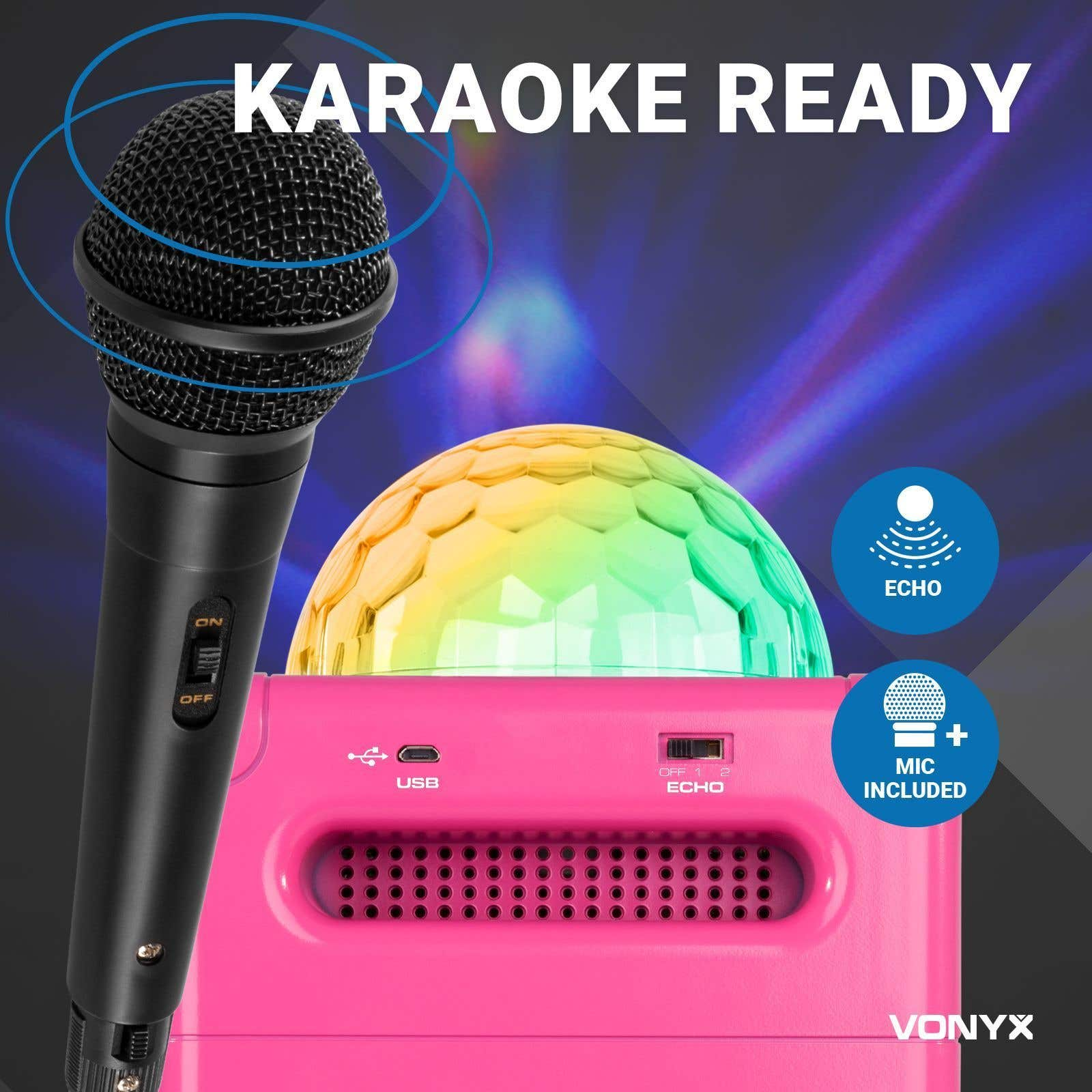 Set de karaoke con micrófono, bola de discoteca y altavoz rosa. El texto dice 'Karaoke Ready'. Micrófono incluido.