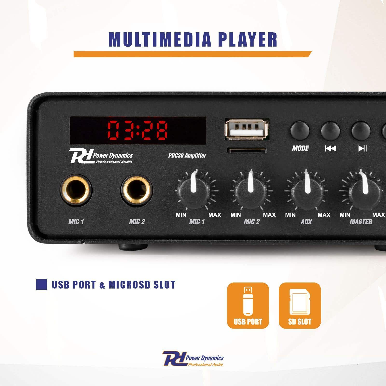 Reproductor multimedia negro con pantalla 03:28. Tiene USB, ranura SD, perillas y botones.