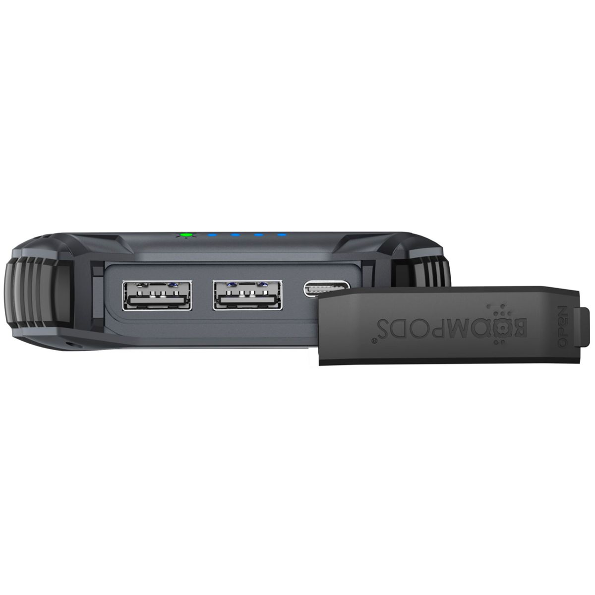 Un power bank BOOMPODS grigio scuro con porte USB e un coperchio della porta aperto. Sono visibili luci blu e verdi.