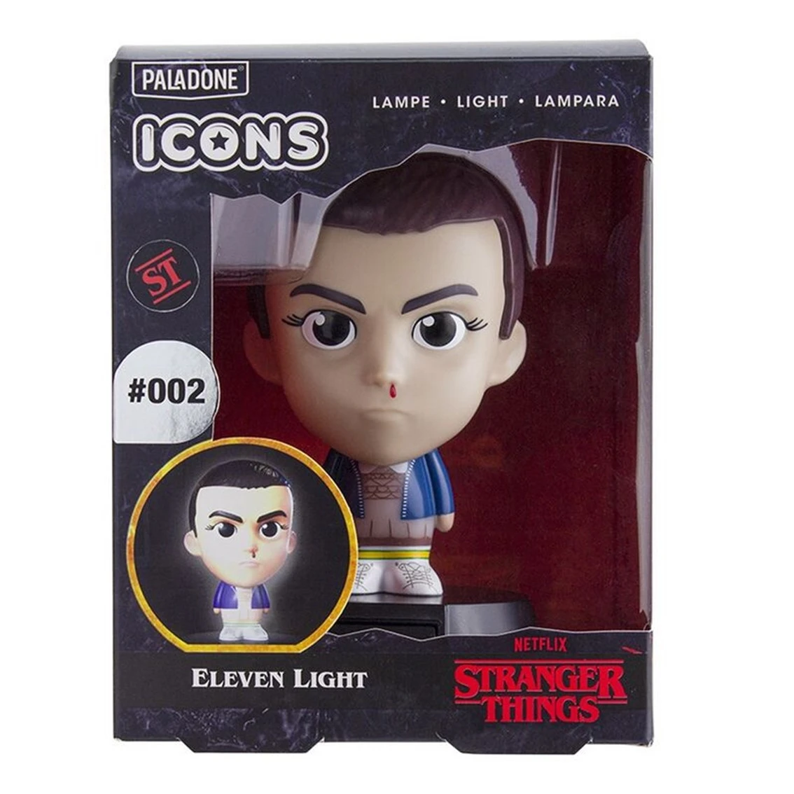 Una figura de luz de Eleven de 'Stranger Things' en una caja. La figura tiene hemorragia nasal. La caja muestra el logo y el nombre del personaje.