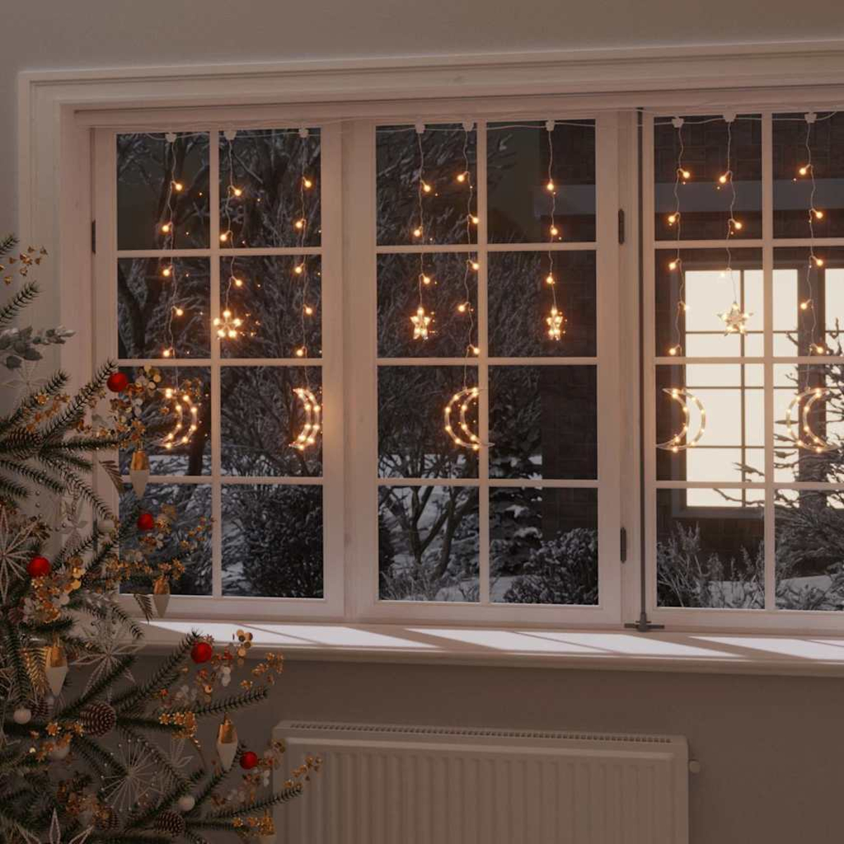 Ein Fenster mit Weihnachtsbeleuchtung, einschließlich Monden, Sternen und hängenden Lichtern. Links ist ein Weihnachtsbaum und unter dem Fenster ein Heizkörper.