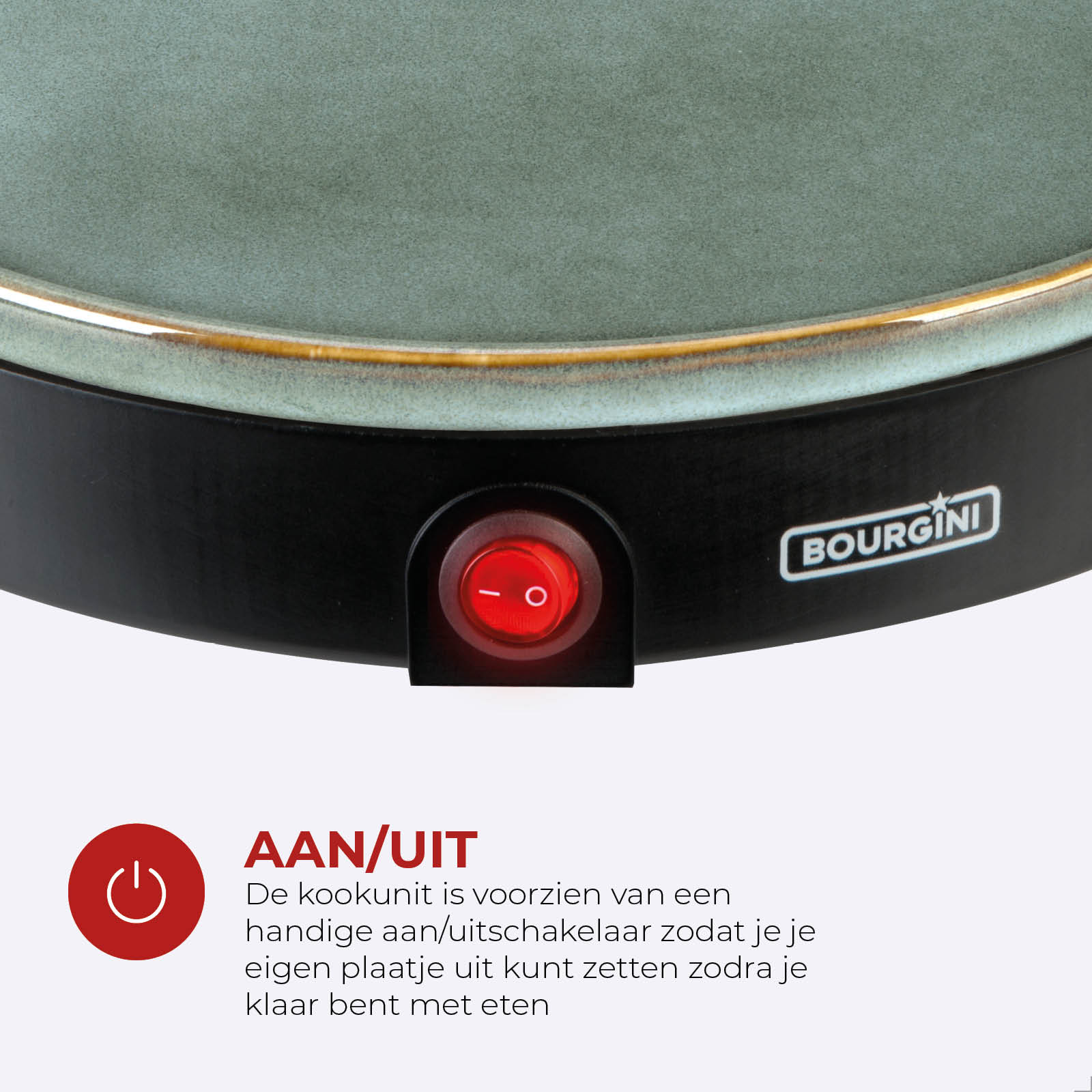 Close-up of a cooking device. A red on/off button is visible. The device has a green surface and black base.