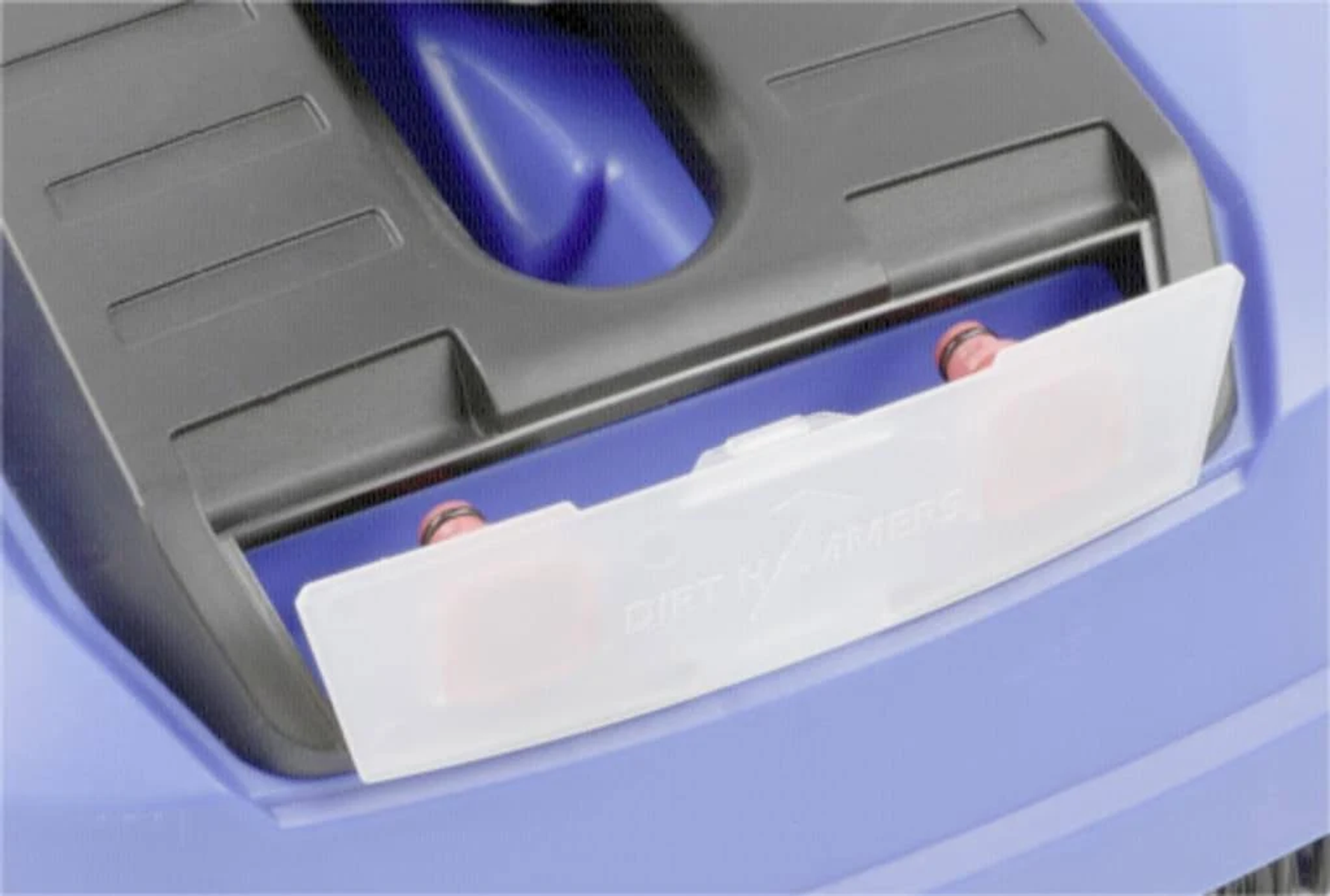 Primo piano di un componente di macchina blu e nero. Una copertura di plastica trasparente rivela componenti rossi. Il testo "DIRT HAMMERS" è visibile.