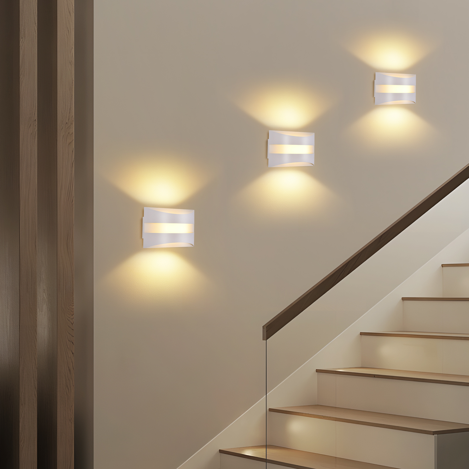 Lampade da parete bianche illuminano una scala. Corrimano e gradini in legno. Sfondo muro beige. Rivestimento in legno verticale a sinistra.