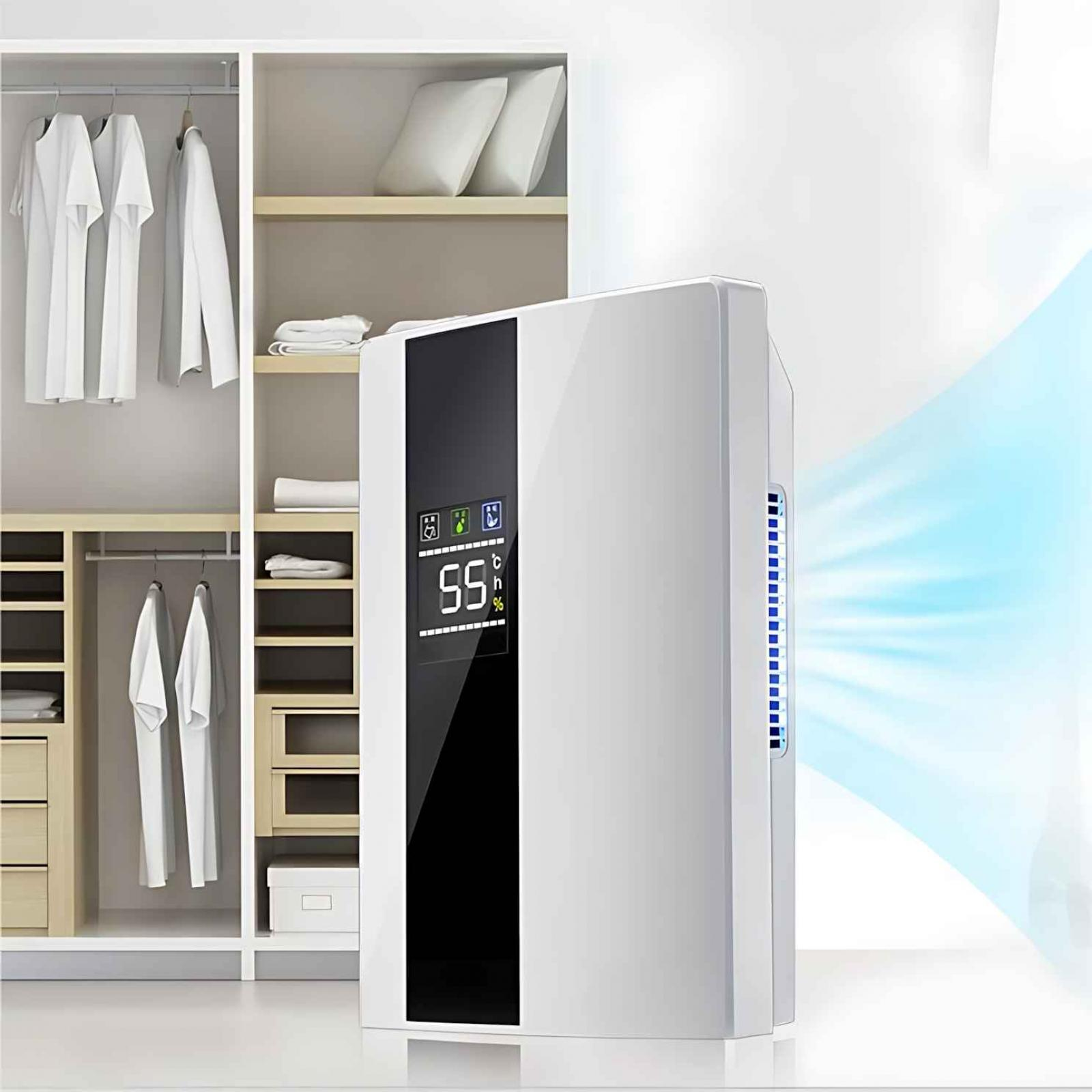 Ein weißer Luftentfeuchter mit digitaler Anzeige neben einem Kleiderschrank mit weißer Kleidung.
