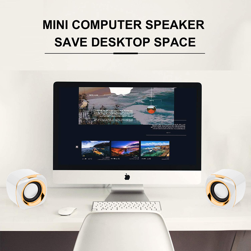 Ein Computer-Setup mit einem Monitor, der Bilder anzeigt, zwei weißen Lautsprechern, einer Tastatur und einer Maus auf einem Schreibtisch.