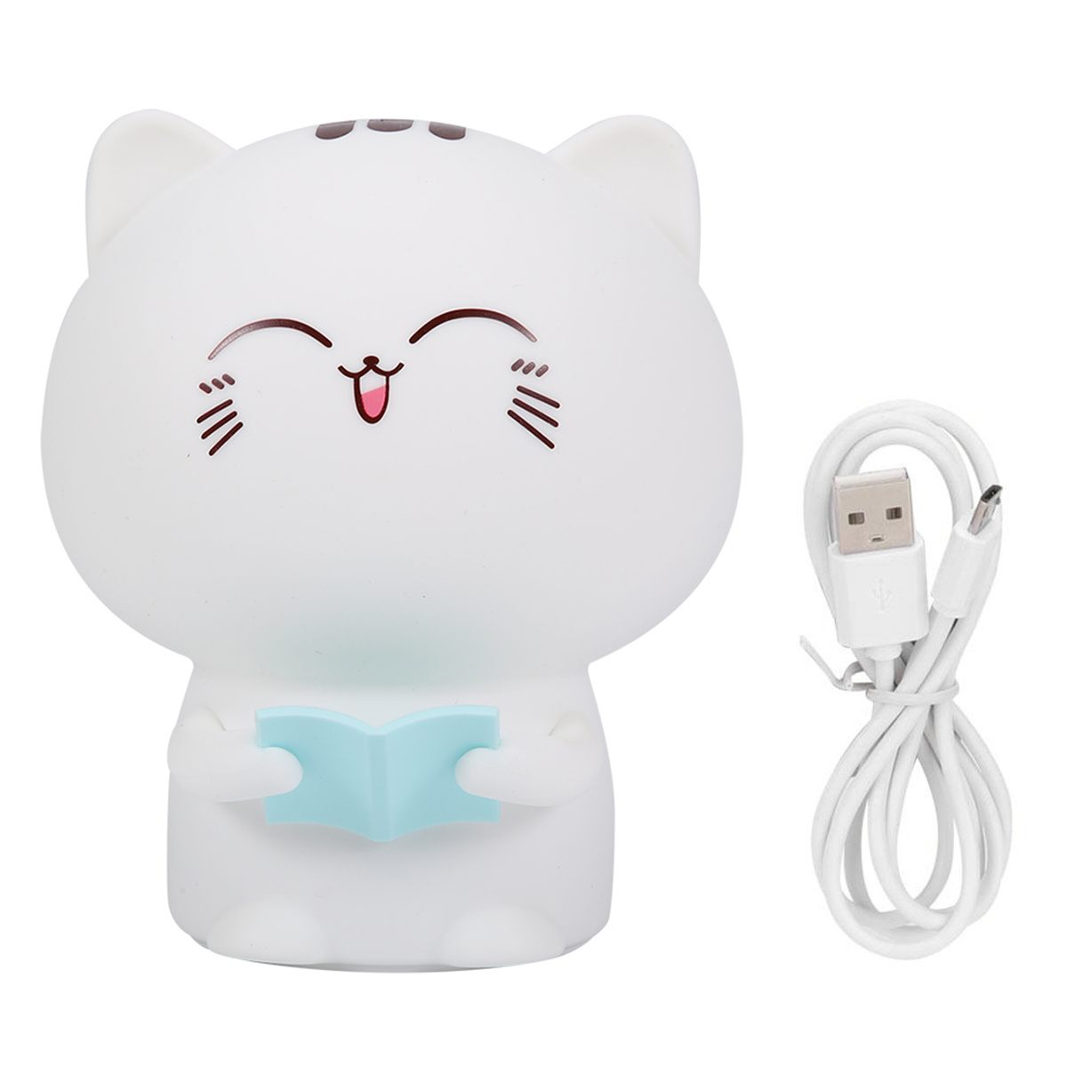 Eine weiße, katzenförmige Lampe hält ein blaues Buch. Daneben liegt ein weißes USB-Kabel.