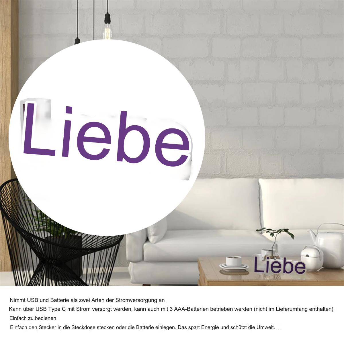 Ein Raum mit weißem Sofa, schwarzem Stuhl, Tisch mit dem Wort 'Liebe' und weißem Kreis mit dem Wort 'Liebe'.