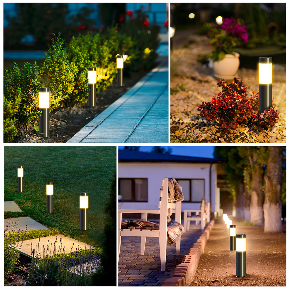 Gartenlichter beleuchten einen Weg und Blumenbeete. Weiße Stühle stehen auf einer Terrasse. Die Szene ist in der Abenddämmerung.
