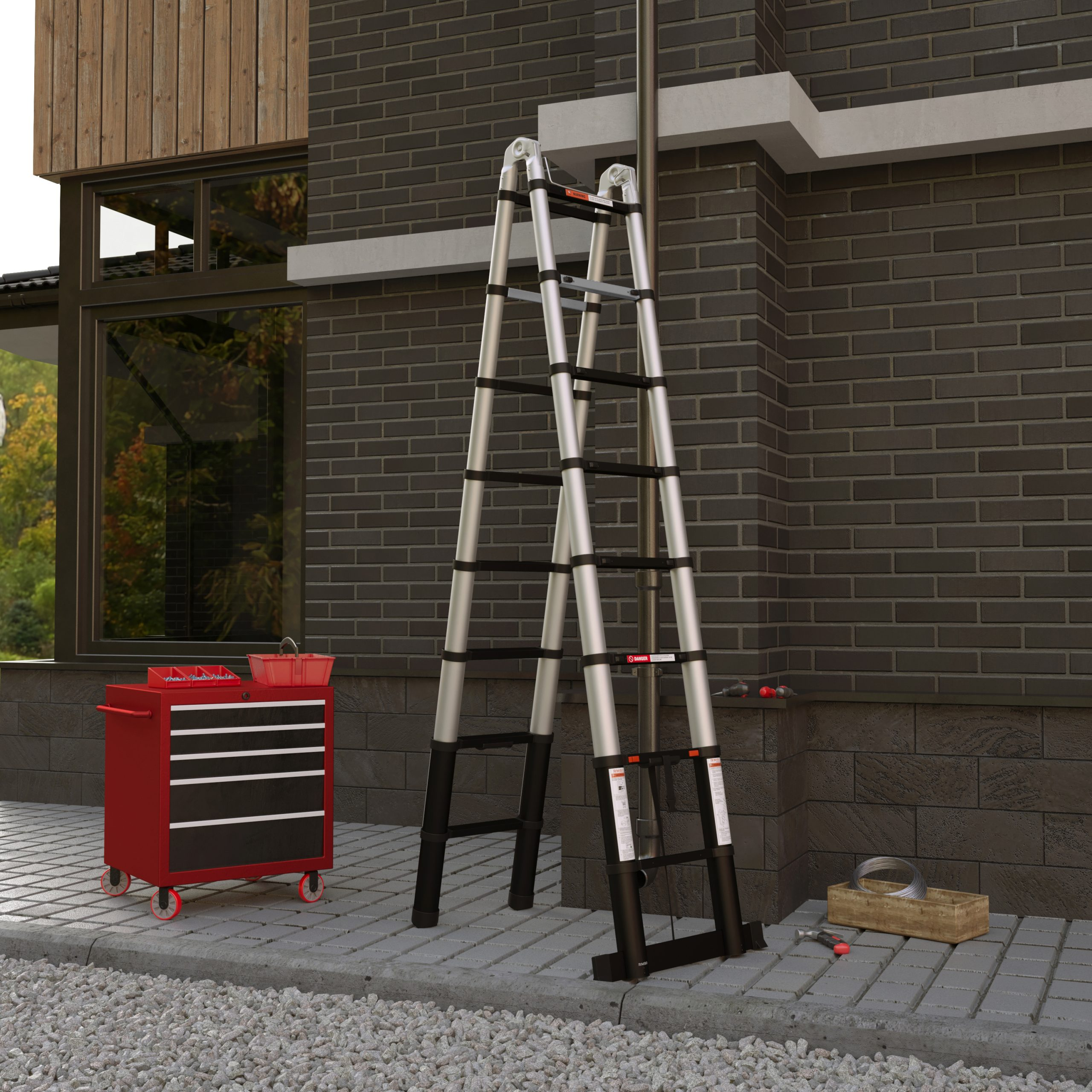 Une échelle en aluminium contre un mur de briques. Une boîte à outils rouge et un chariot à outils à proximité.