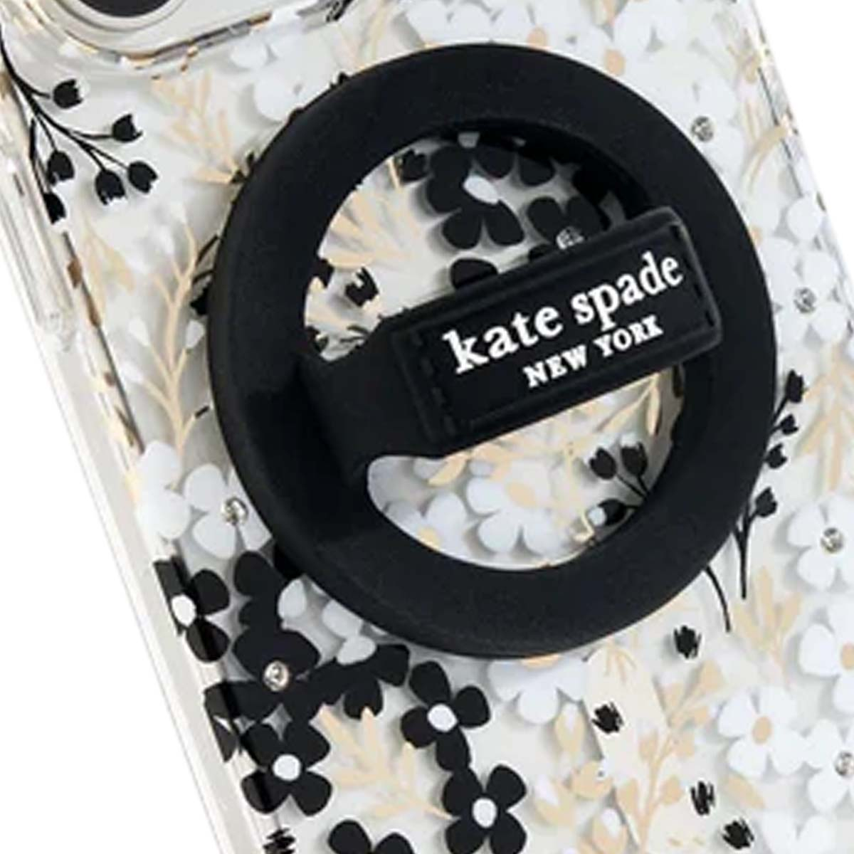 Una custodia trasparente per telefono con un design floreale in bianco e nero, con un supporto ad anello nero con il logo 'kate spade NEW YORK'.