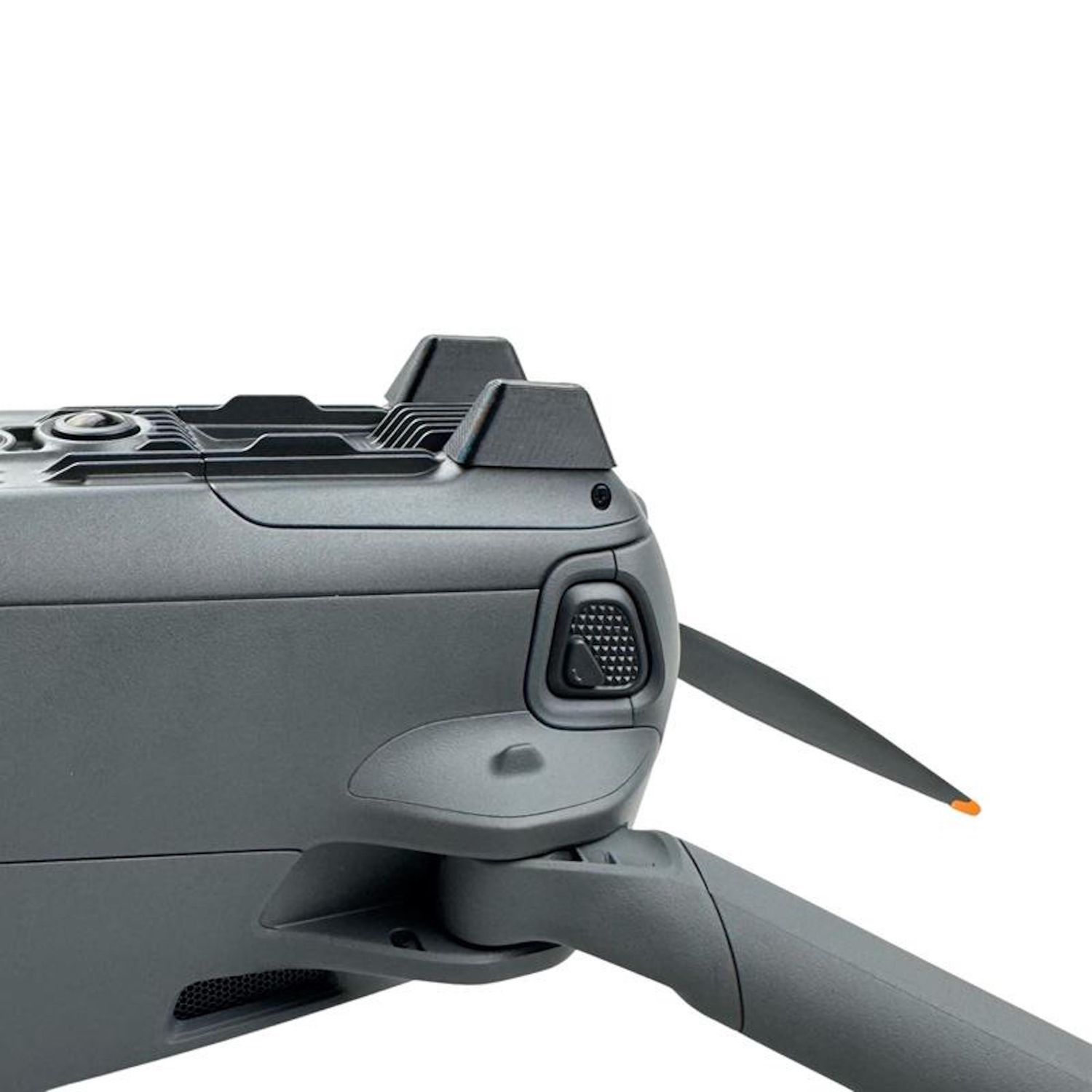 Primo piano di un drone grigio, con elica con punta arancione, pulsanti e prese d'aria. Sfondo bianco.