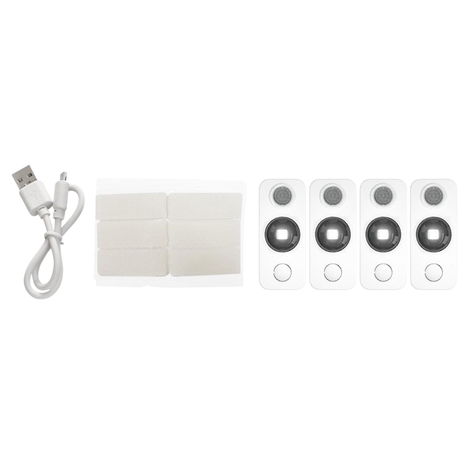 Das Bild zeigt ein weißes USB-Kabel, weiße Klebestreifen und vier weiße rechteckige Geräte mit dunklen Kreisen.