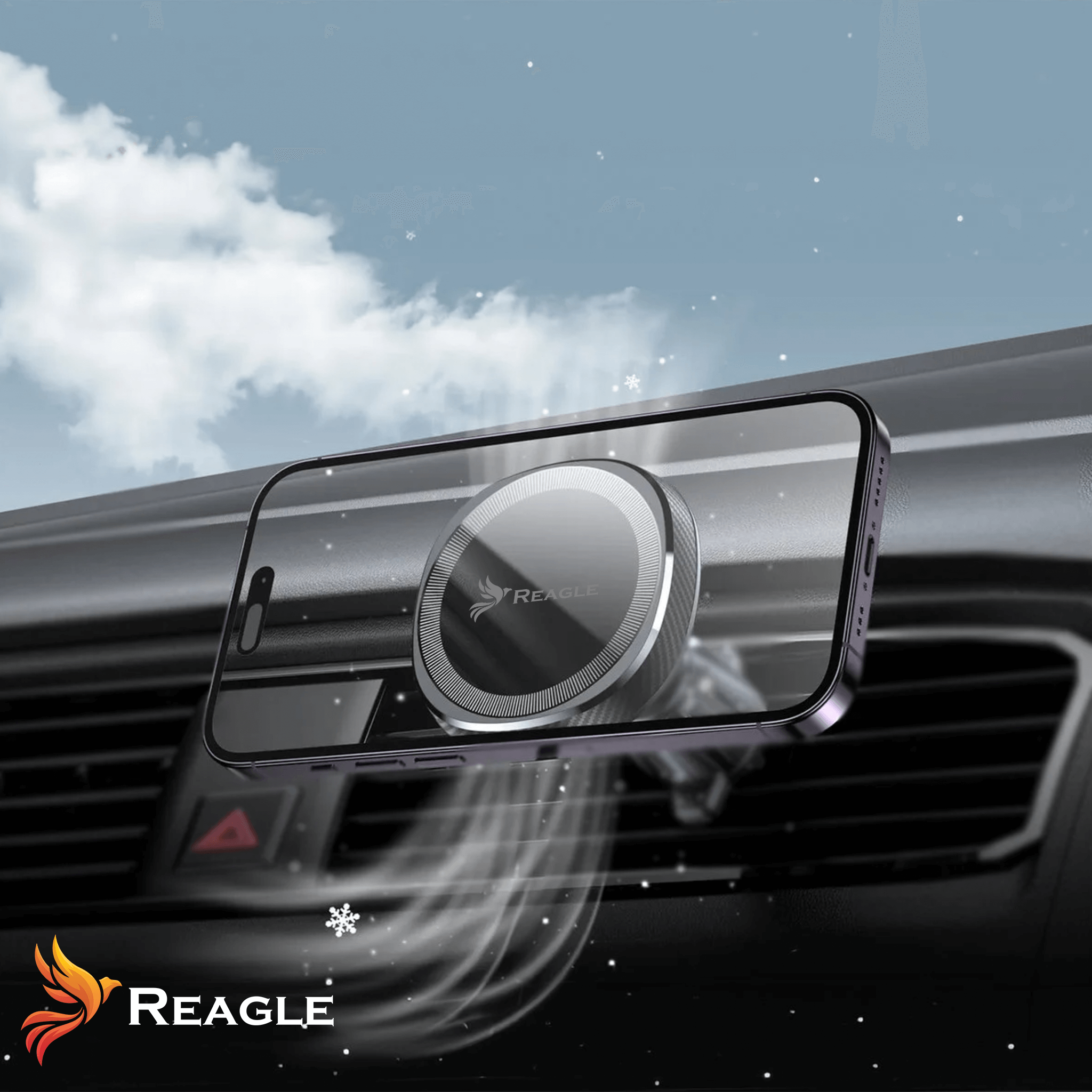 Telefon magnetycznie przymocowany do uchwytu wentylacyjnego. Chmury i płatki śniegu w tle. Widoczne logo 'REAGLE'.