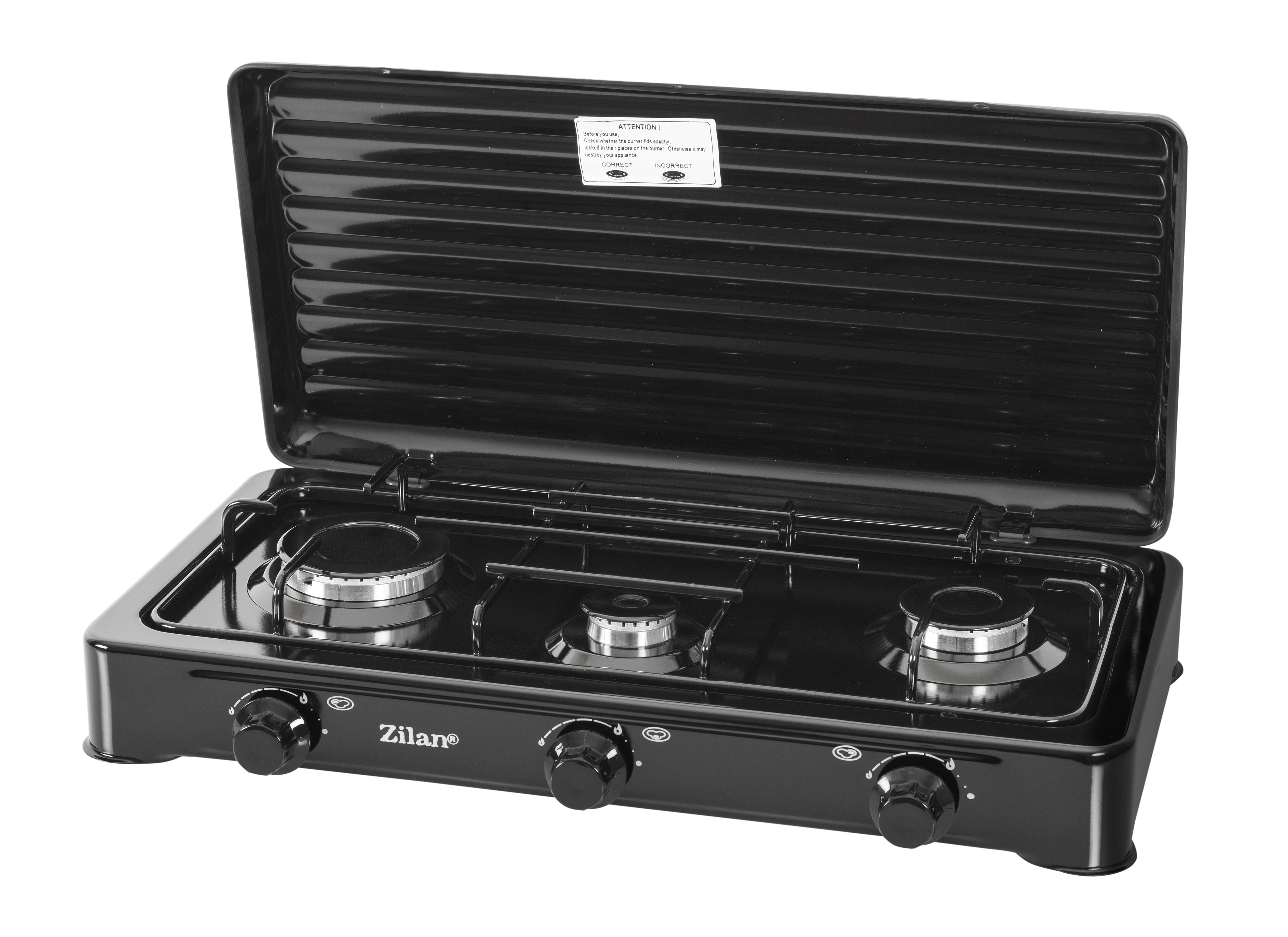 Czarna przenośna kuchenka gazowa z trzema palnikami i klapą. Widoczna jest marka Zilan.
