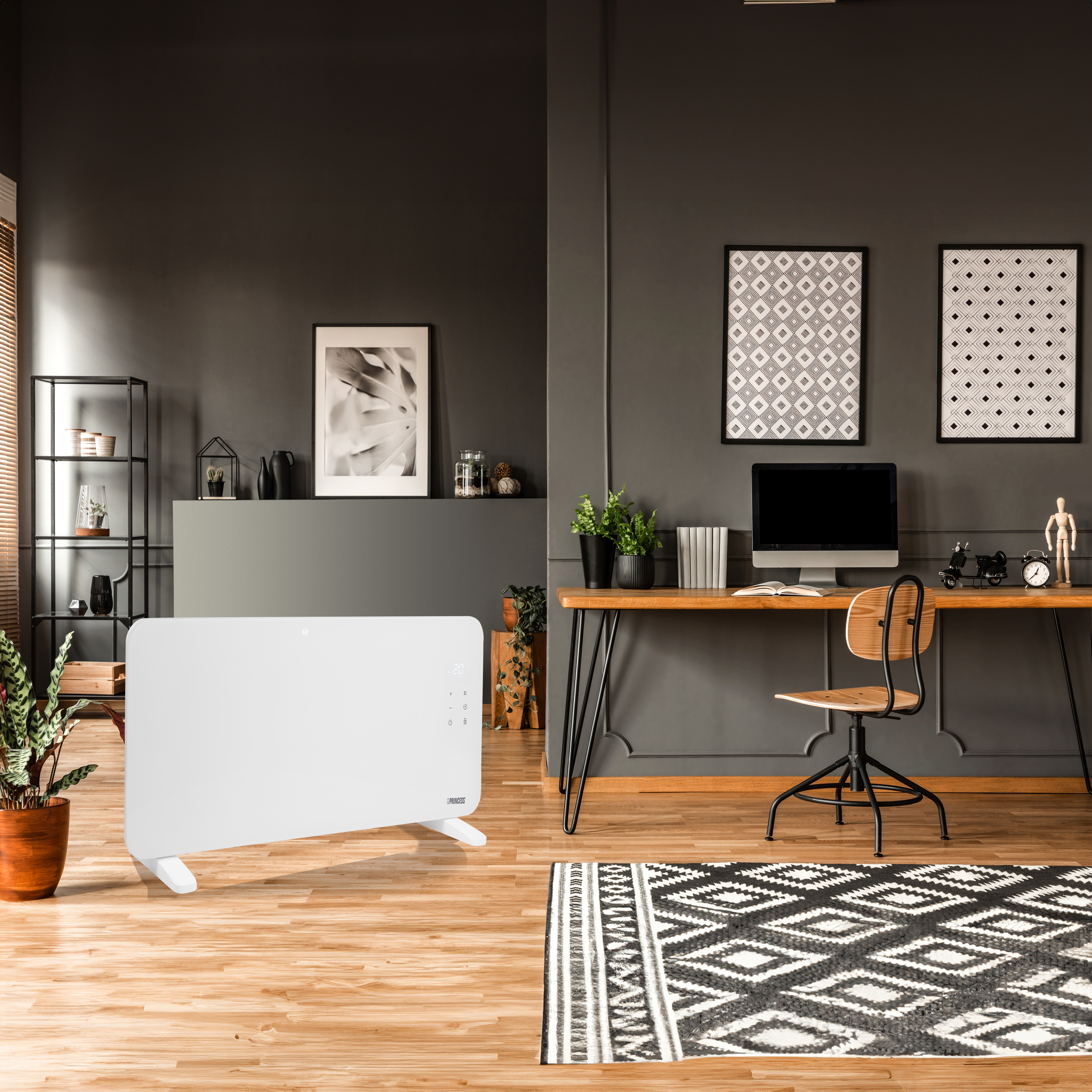 Een witte kachel staat in een kamer met een bureau, kunstwerken en een patroonkleed.