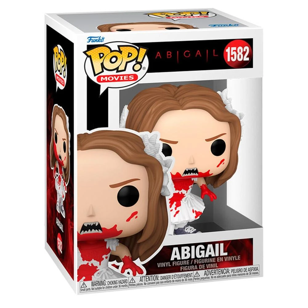 Una figura Funko Pop de Abigail, personaje de una película. Viste un vestido blanco manchado de sangre. La caja tiene una etiqueta de advertencia.
